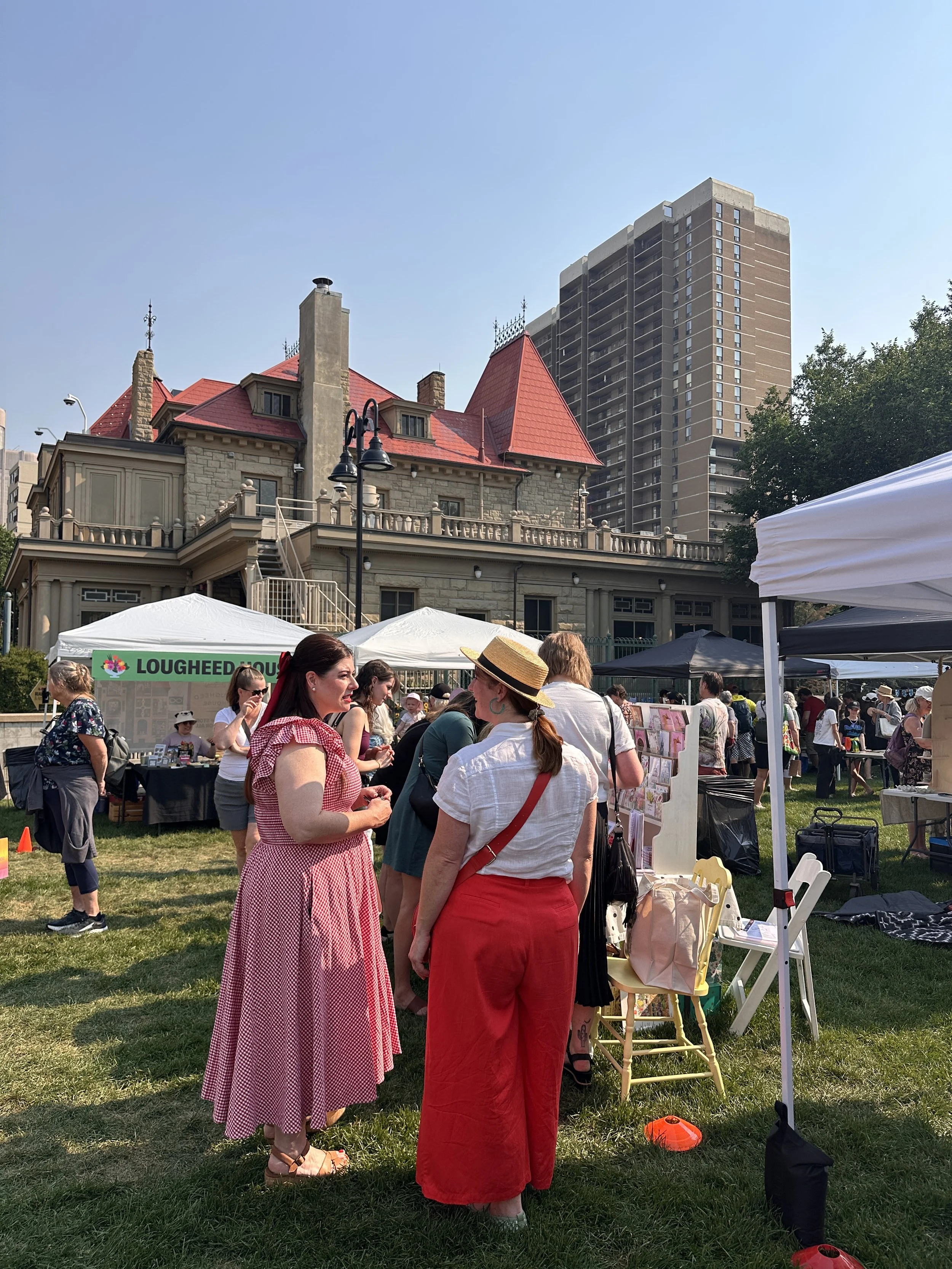 Flower market visitors in front of Lougheed House