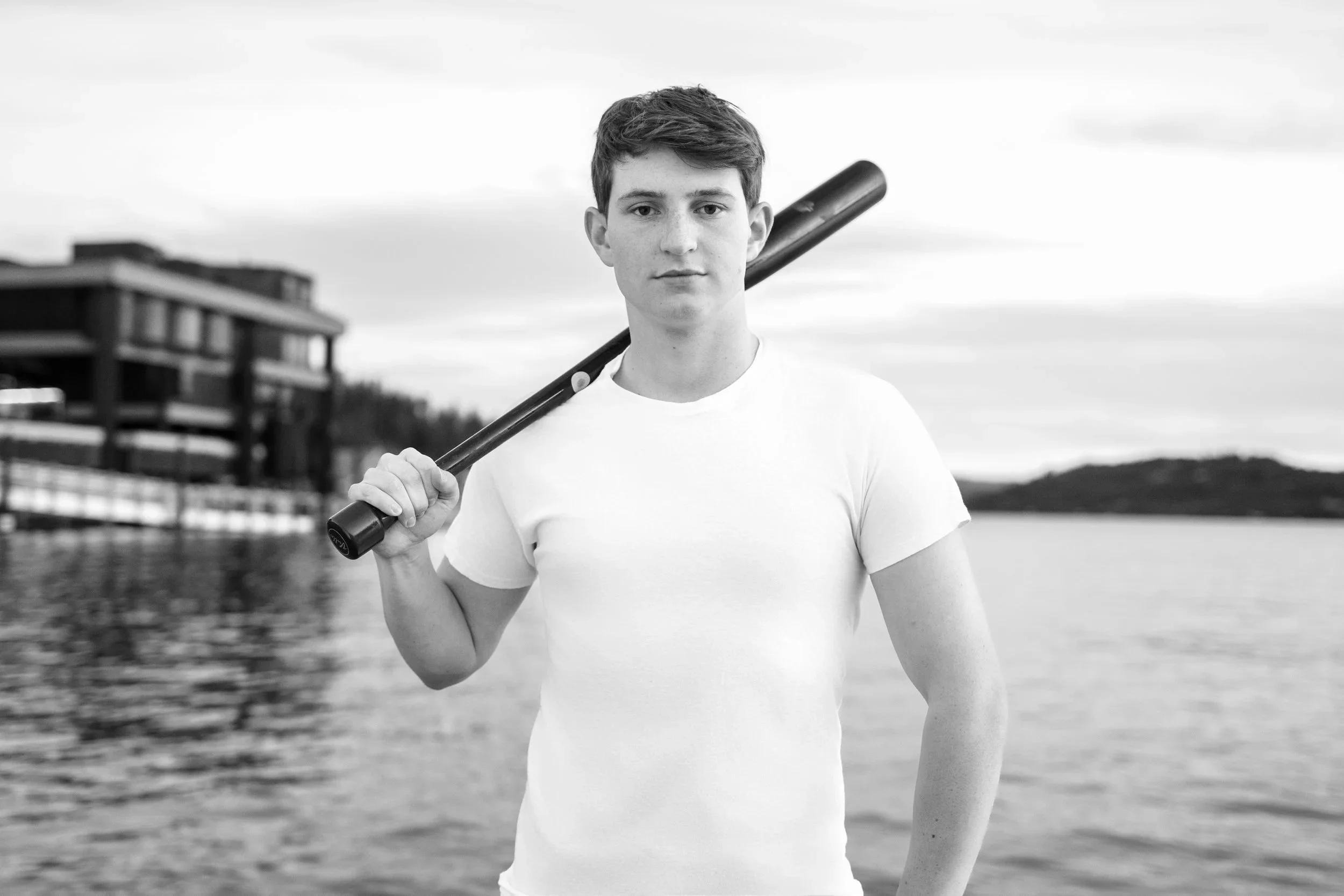 Senior photo of a high school boy holding a baseball bat in Coeur d'Alene, Idaho.