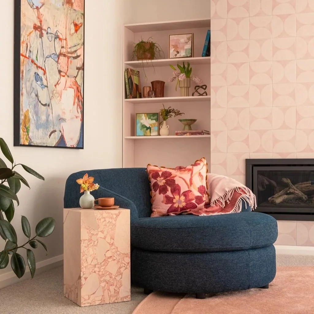 Blue cuddle sofa pink tiled fireplace living room