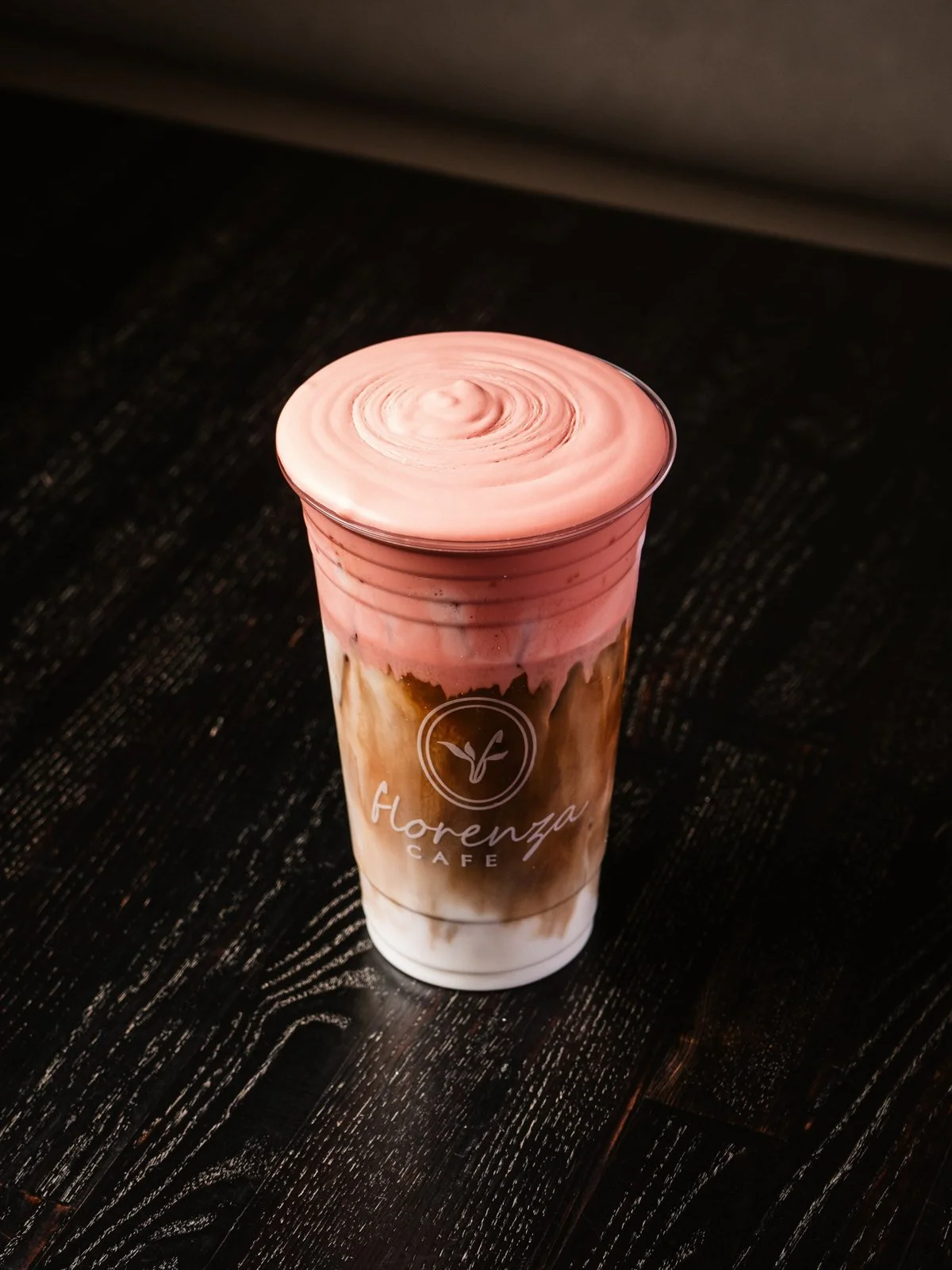 Iced latte topped with pink cold foam