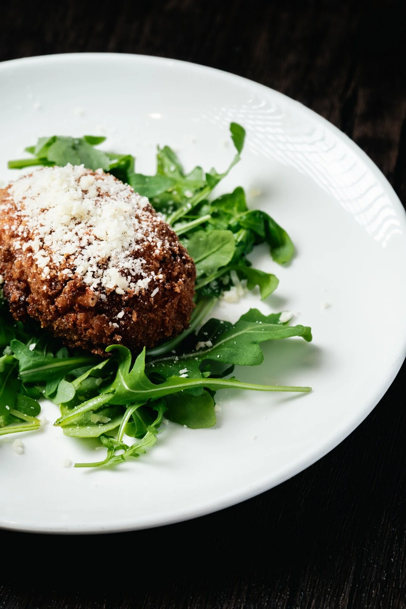 Arancini are classic Italian rice balls made with creamy risotto, delicately seasoned and filled with rich ingredients like melted mozzarella, savory rag&ugrave;, or fresh herbs. Each one is hand-formed, coated in breadcrumbs, and fried to a perfect 