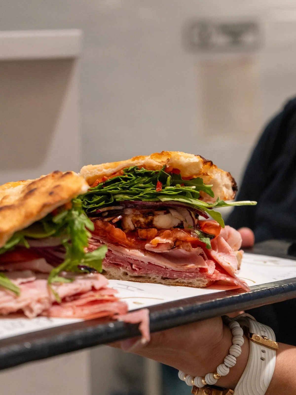Florenza Italian panini layered with Italian meats, fresh mozzarella, tomato, and arugula.