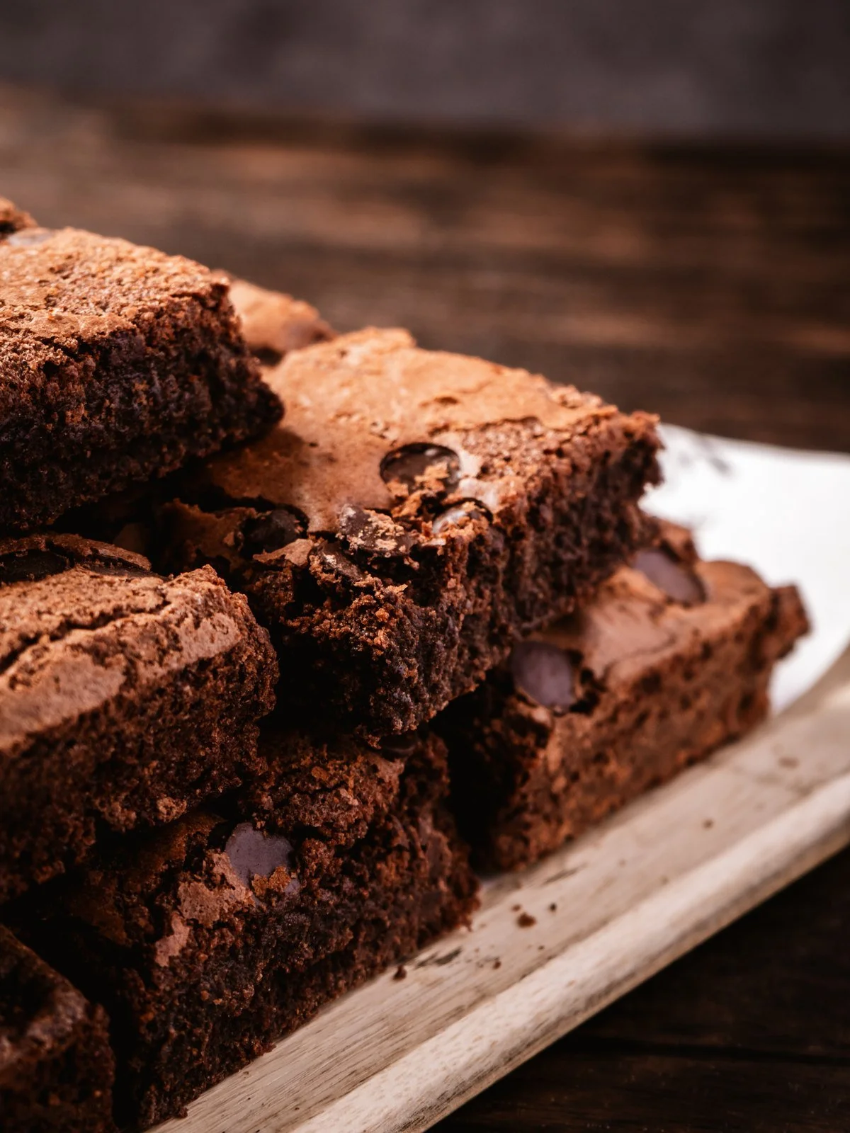 Chocolate brownies stacked on a plate