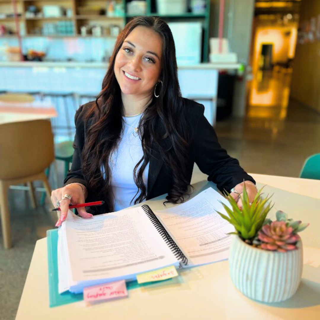founder of Soaring Learners, Robyn Bench, sitting with a planning book