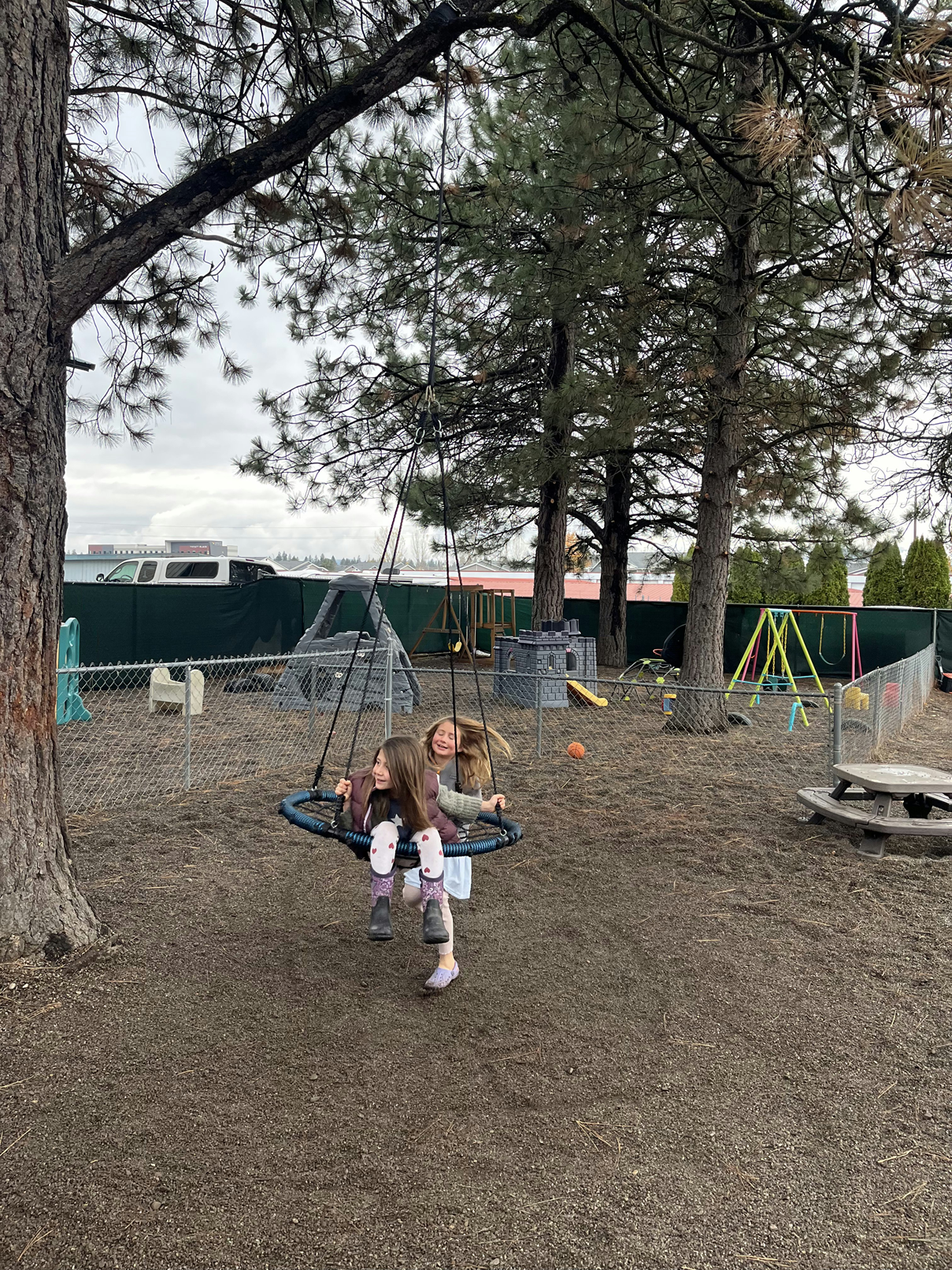 girls playing on the swing at Soaring Learners