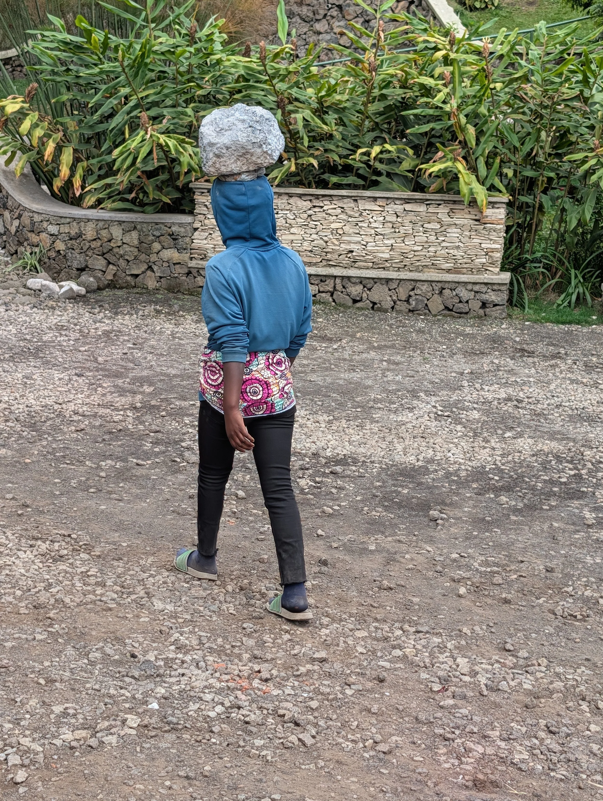 She's carrying a small boulder on her head!!