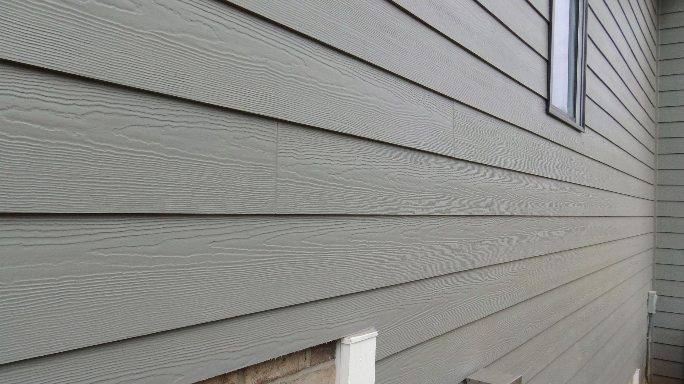 Close-up of horizontal grey siding on the exterior of a house.