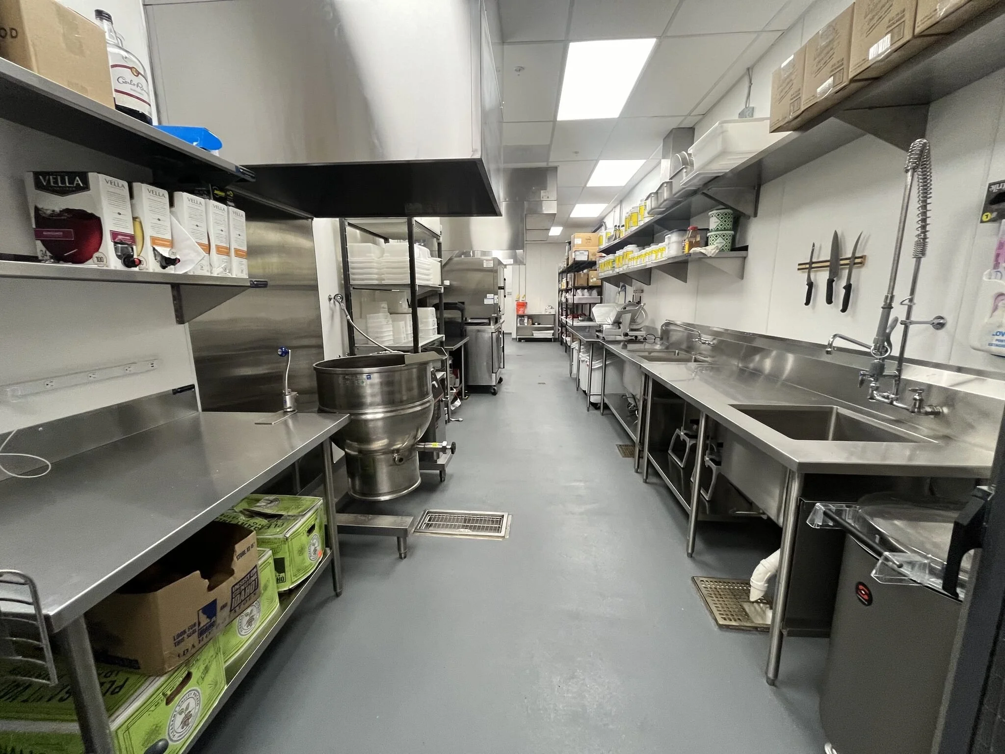 Interior view of kitchen area showcasing an organized line of stainless steel equipment  #stoneyriver