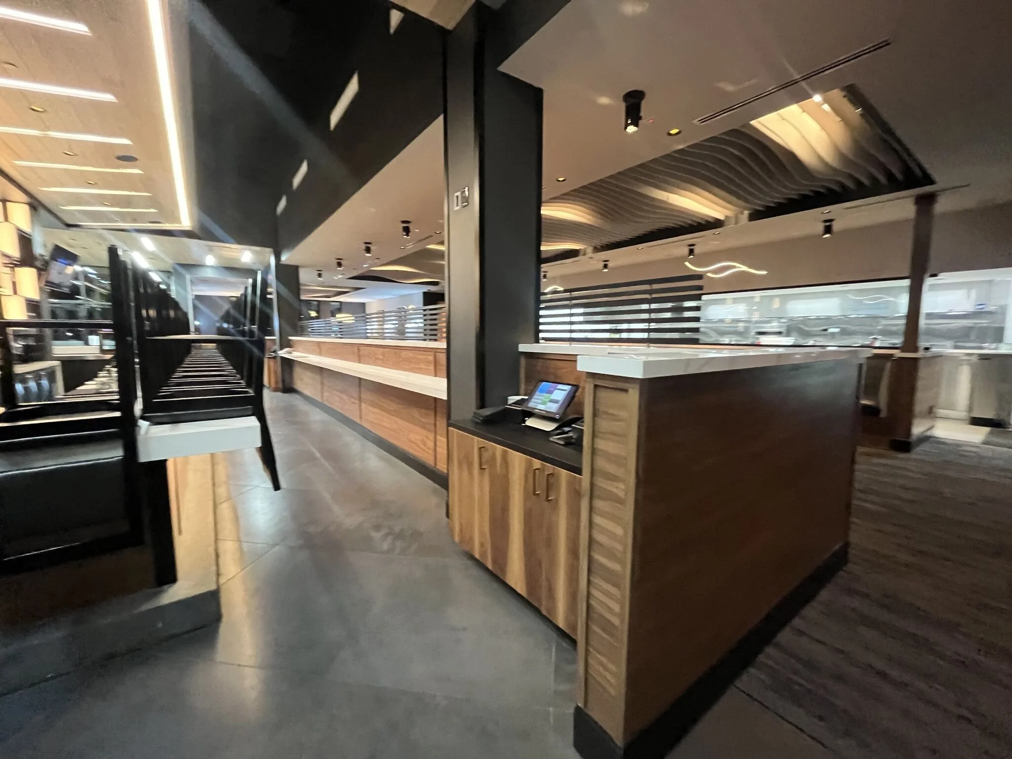 Interior view of bar area and employee computer terminal with cool wave panel ceiling. #stoneyriver