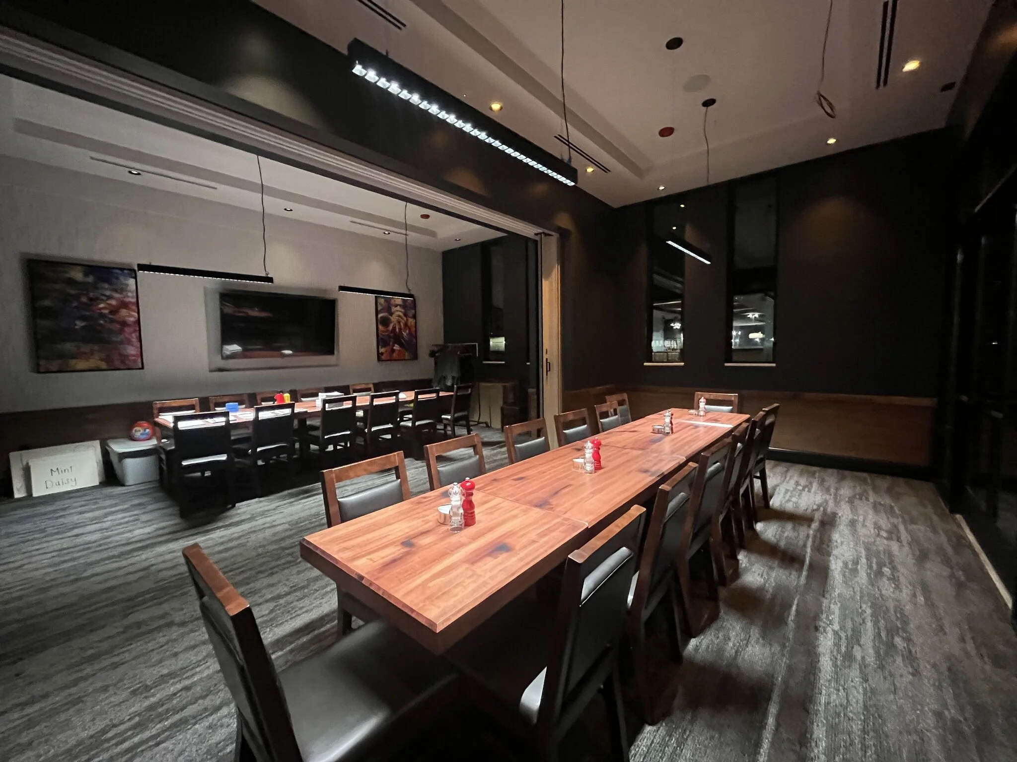 Interior view of private dining area with two tables with 12 chairs around. Soft lighting #stoneyriver