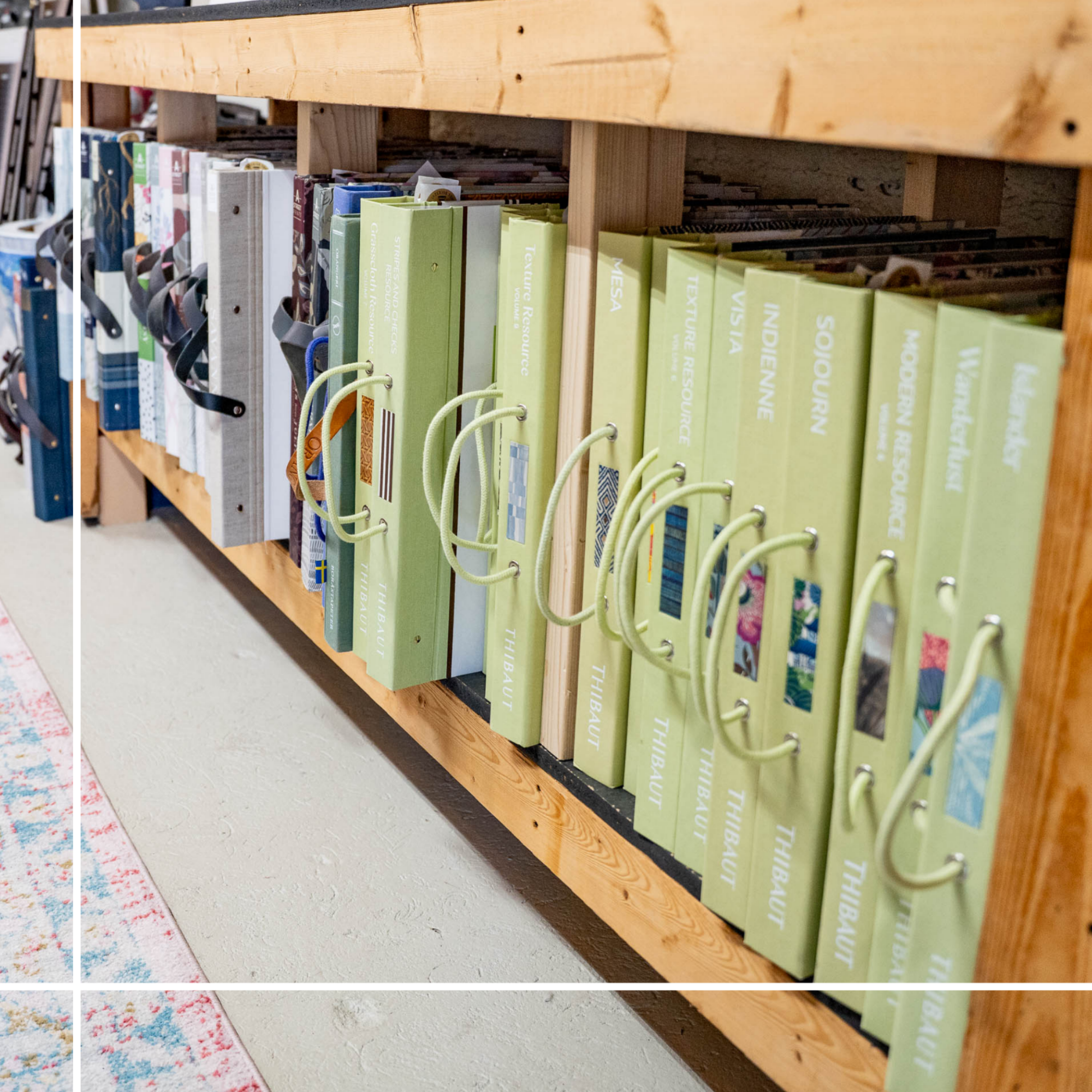 Books organized on a wooden shelf, including titles related to textiles, indigenous knowledge, and modern resource subjects.