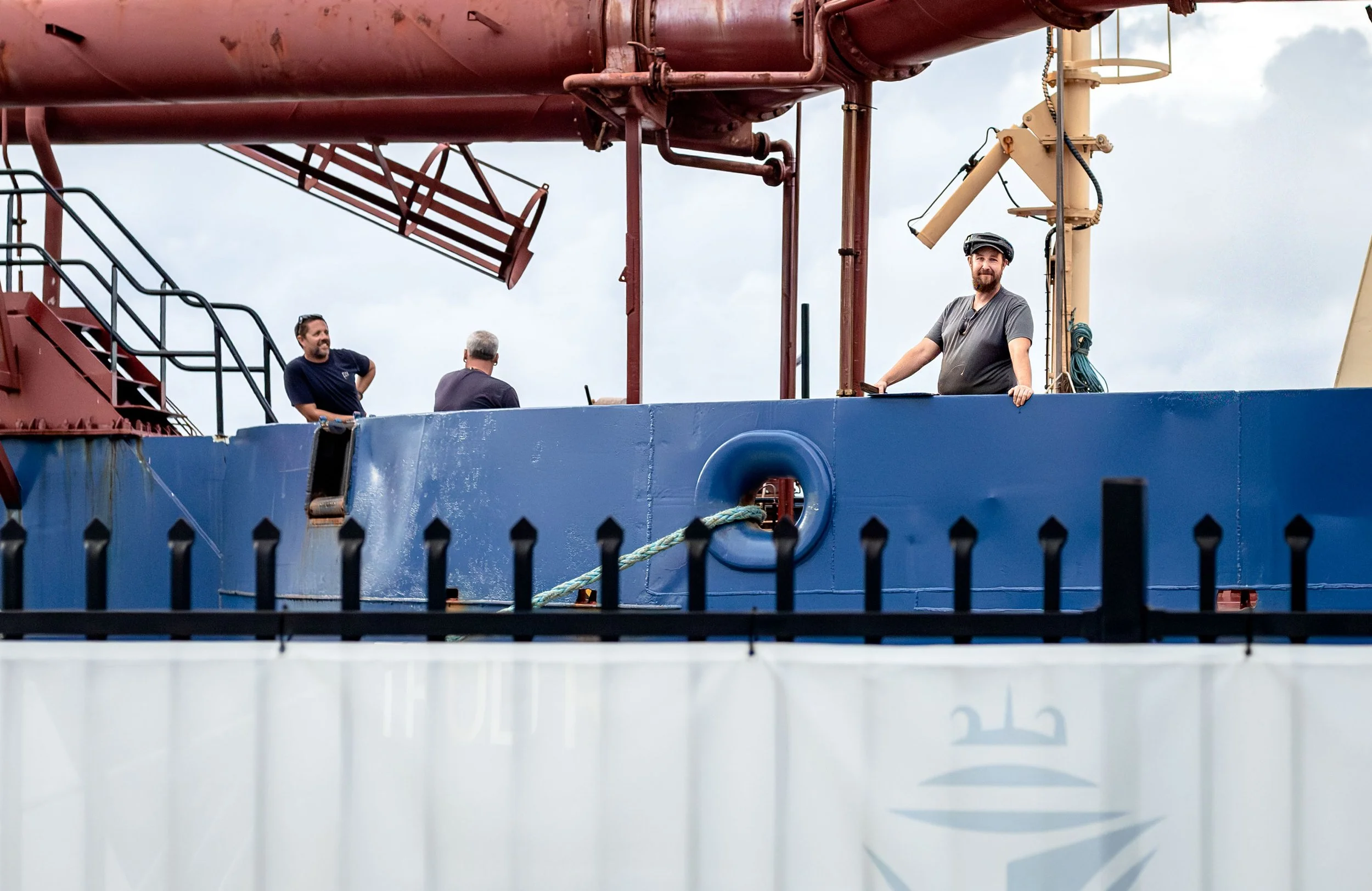 Sailors from a visiting vessel stand at Gold Coast Harbor, Australia.