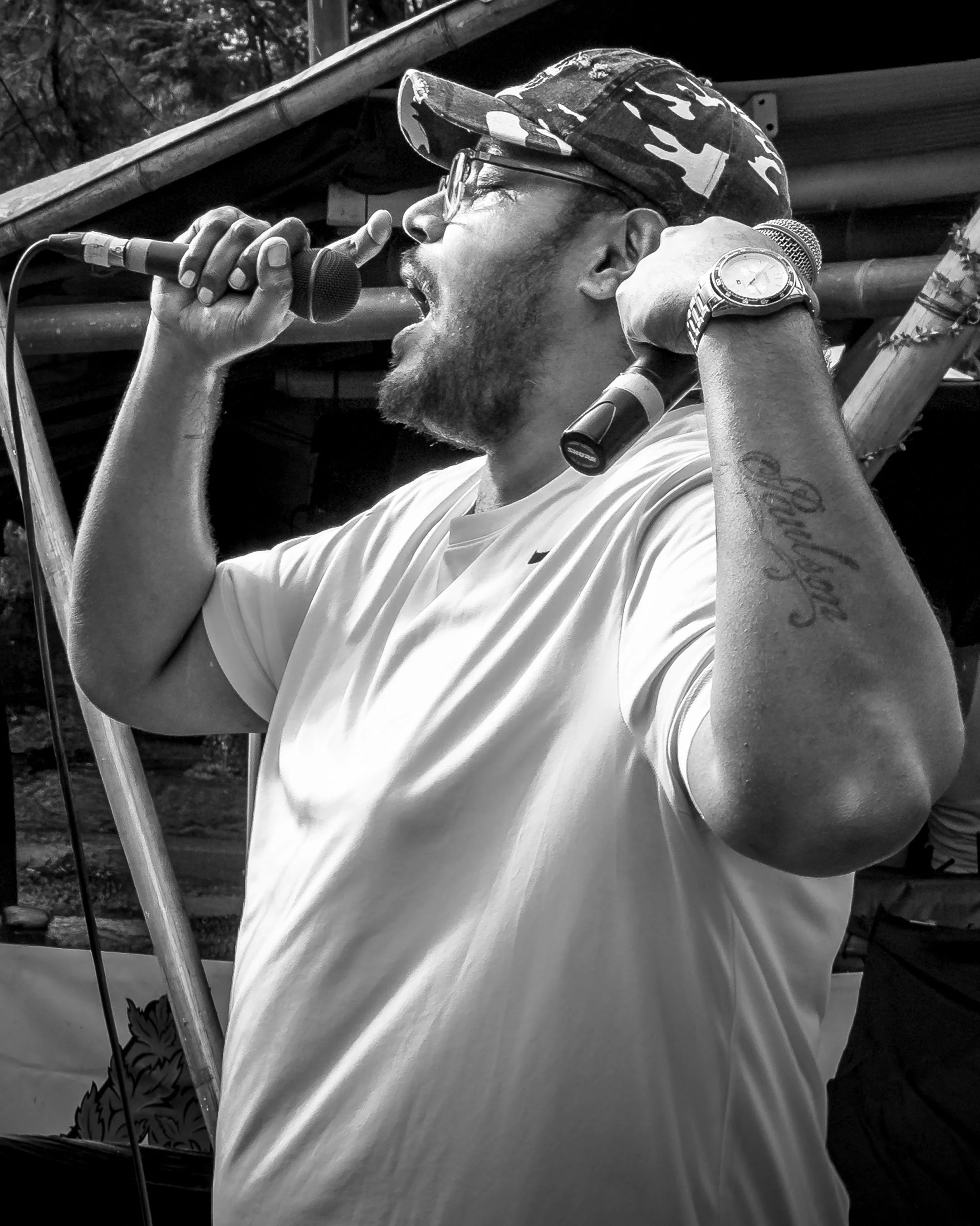 A member of East Coast Brotherhood captured in an intimate portrait, his authentic presence reflecting the raw energy and urban culture of the hip-hop collective.