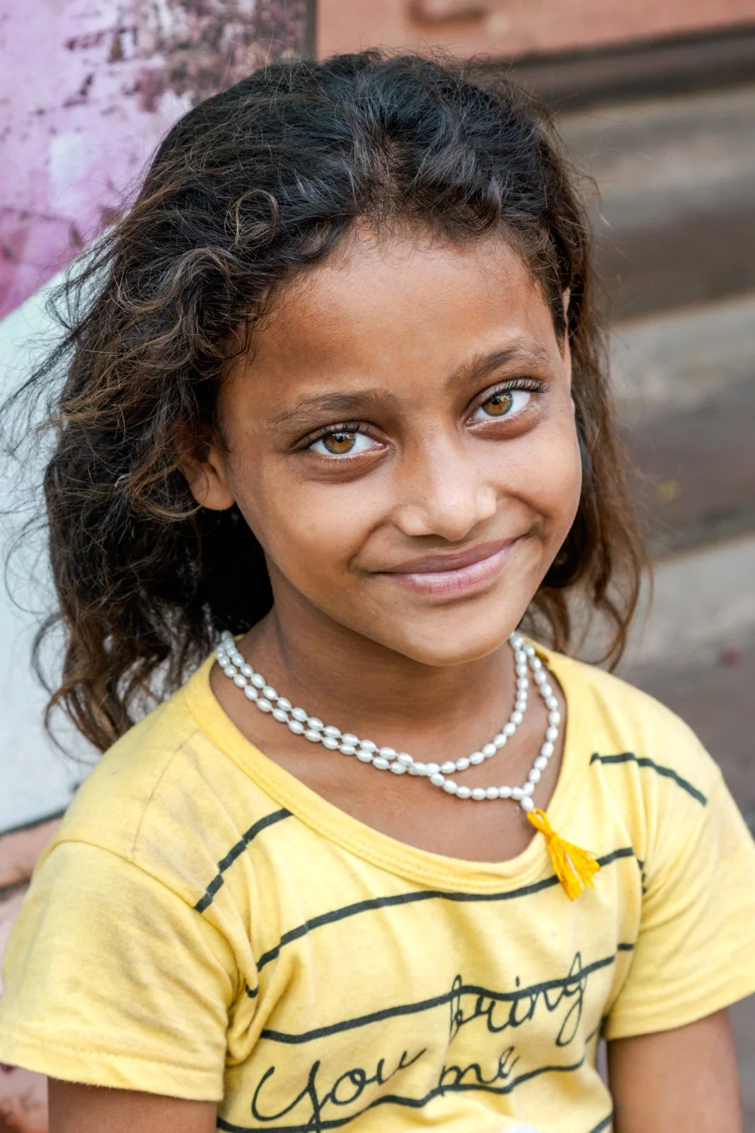 Portrait of a child in Varanasi, India captured in natural street light.