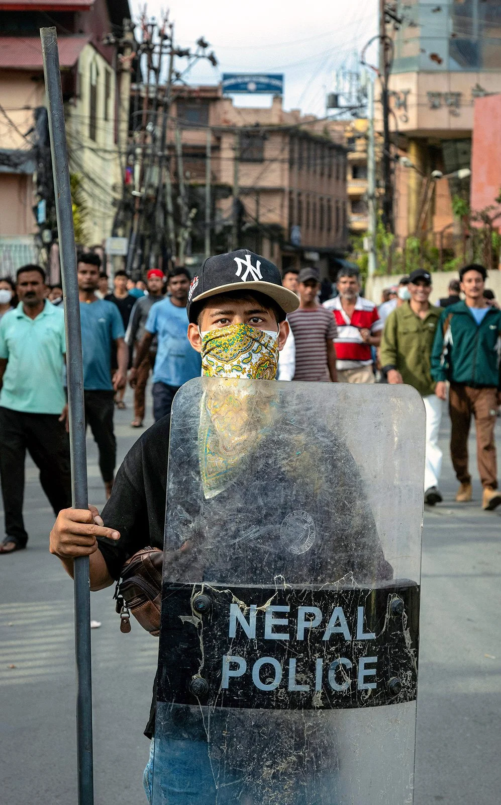 A protester in Kathmandu displays a police shield acquired during demonstrations, September 2025.