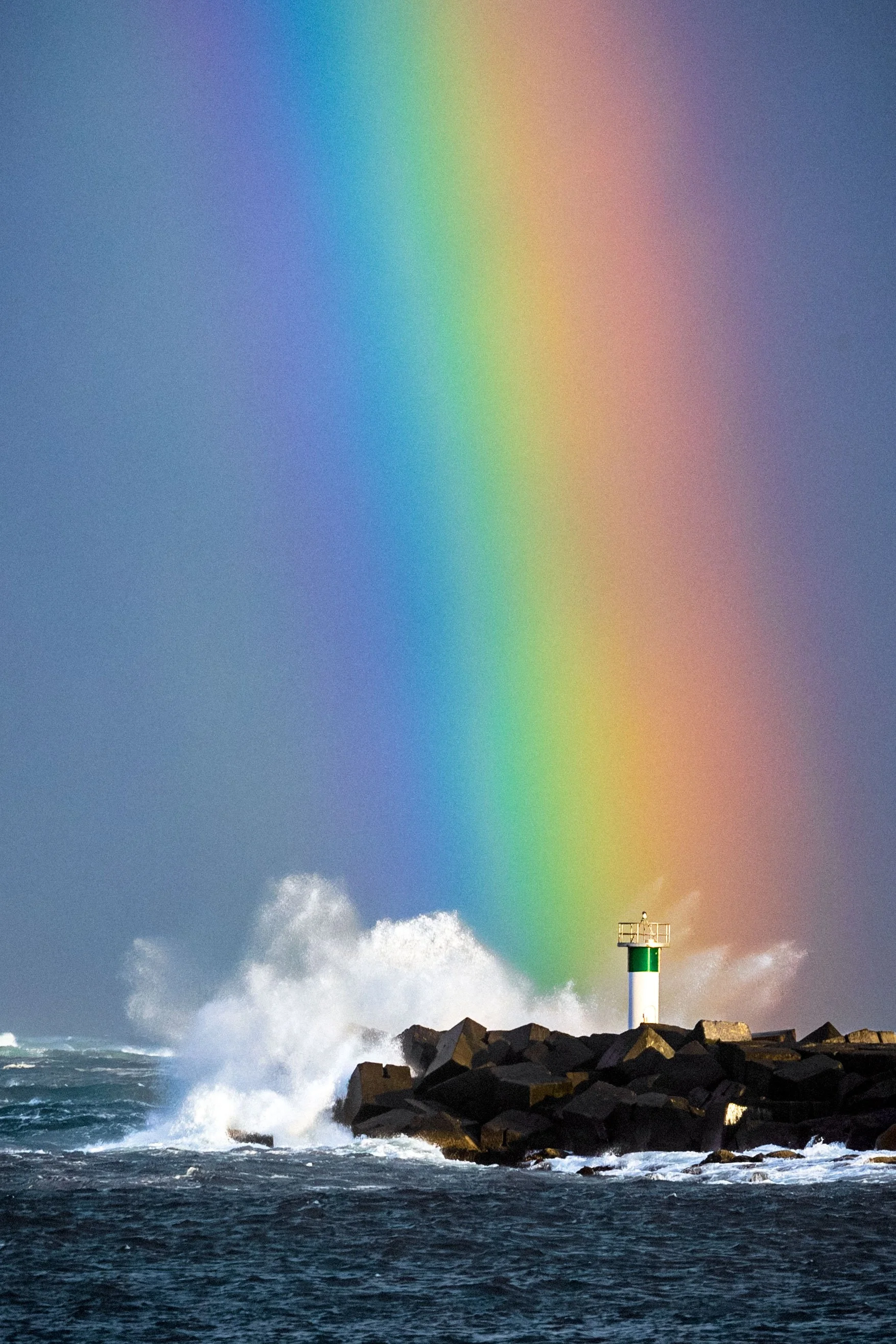 The Spit pier on the Gold Coast illuminated in vibrant rainbow lights, captured moments before the arrival of Cyclone Alfred.
