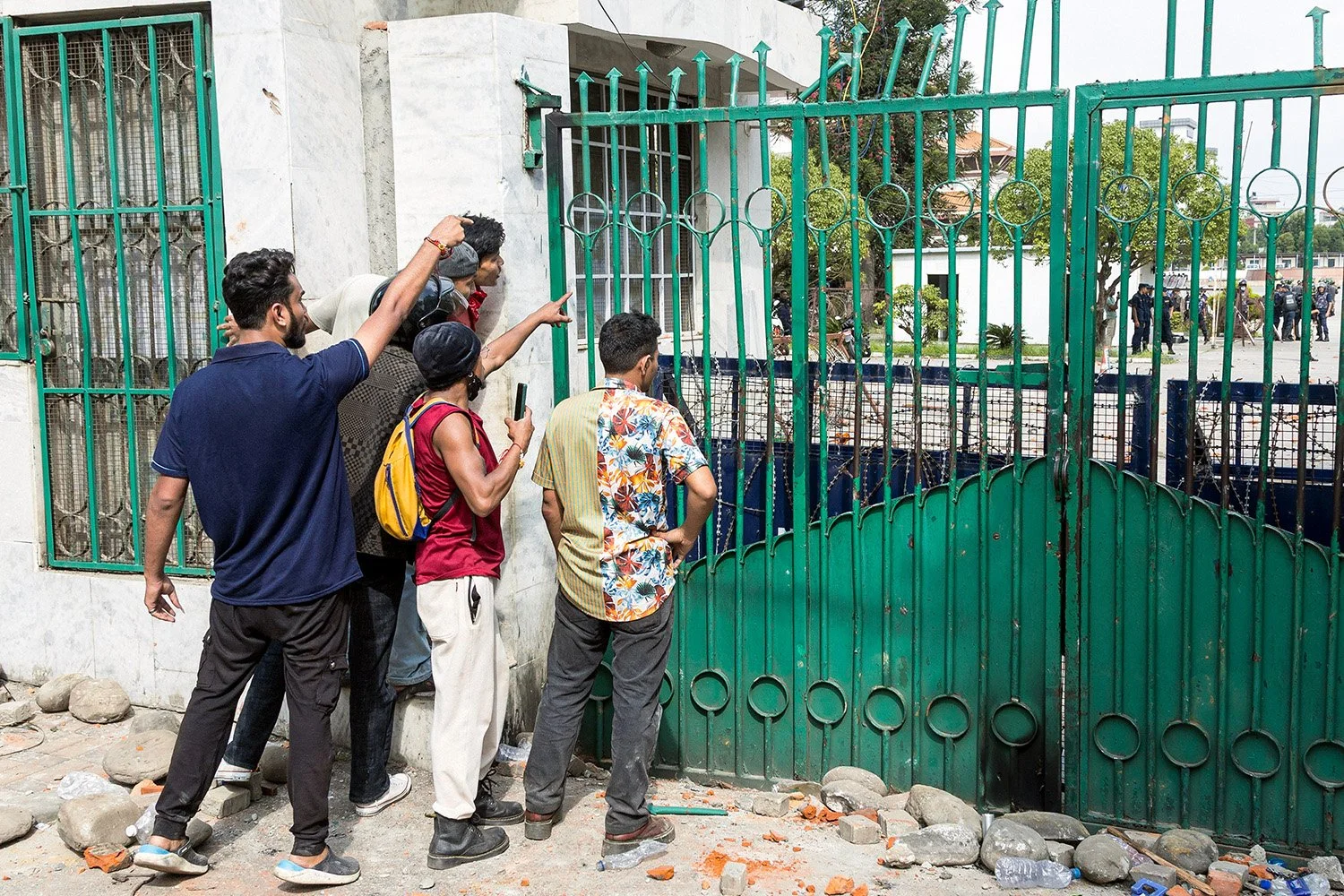 [Act I: Assembly]. Protesters shout at the Parliament gates.