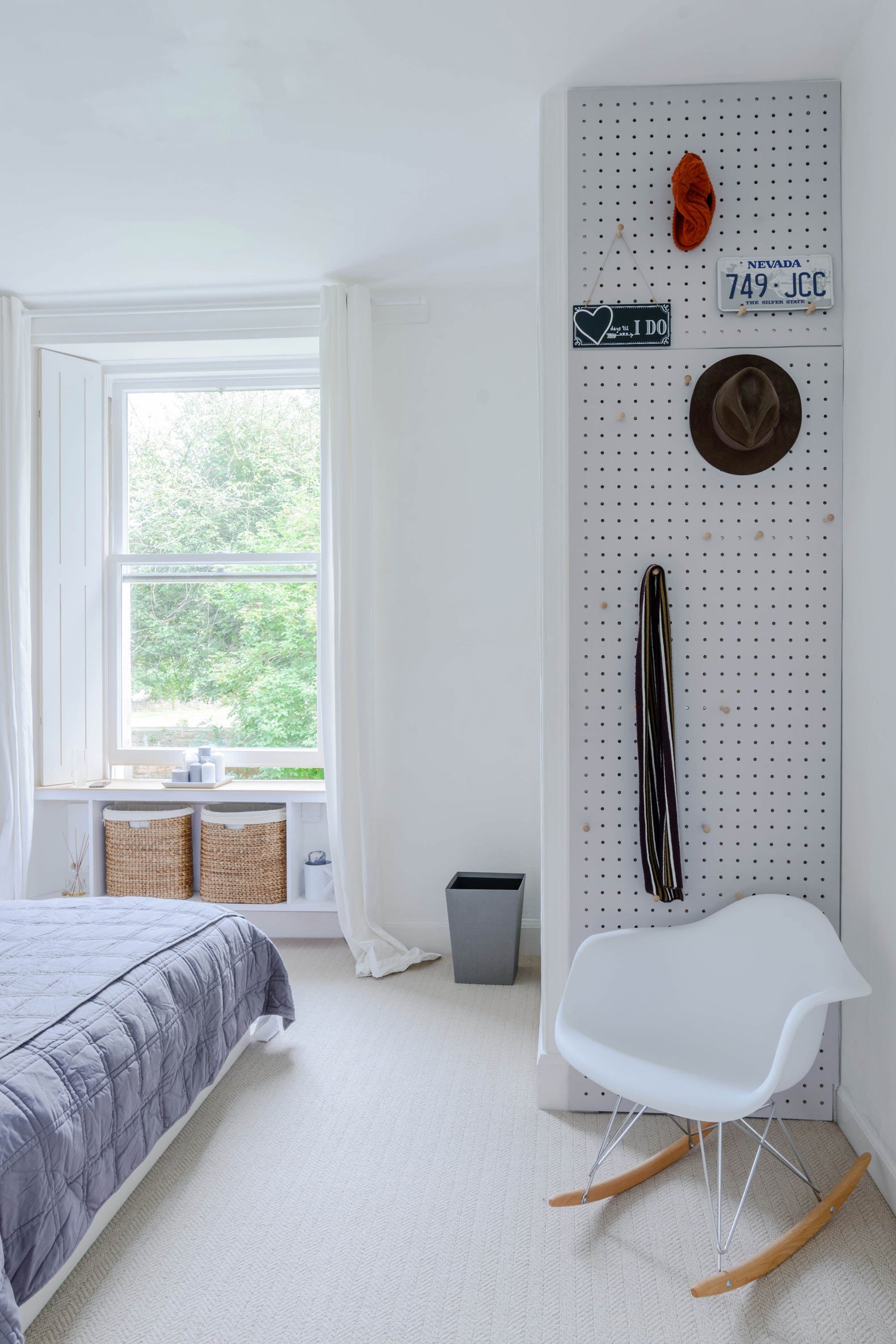 Modern interior architecture of a bedroom space with neutral carpet and white walls.