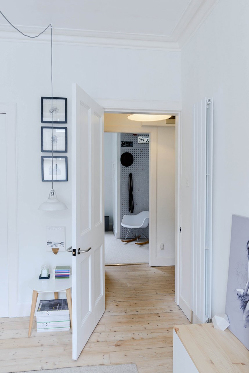 Modern interior architecture of a hall space with wooden floor and white walls.