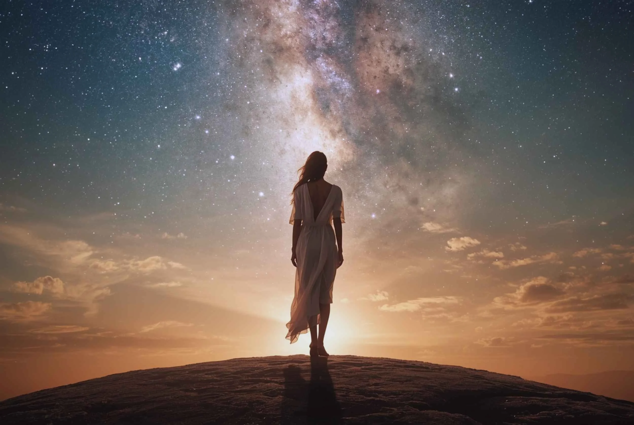 Grounded woman integrating spiritual awakening energy while standing calmly beneath a cosmic sky