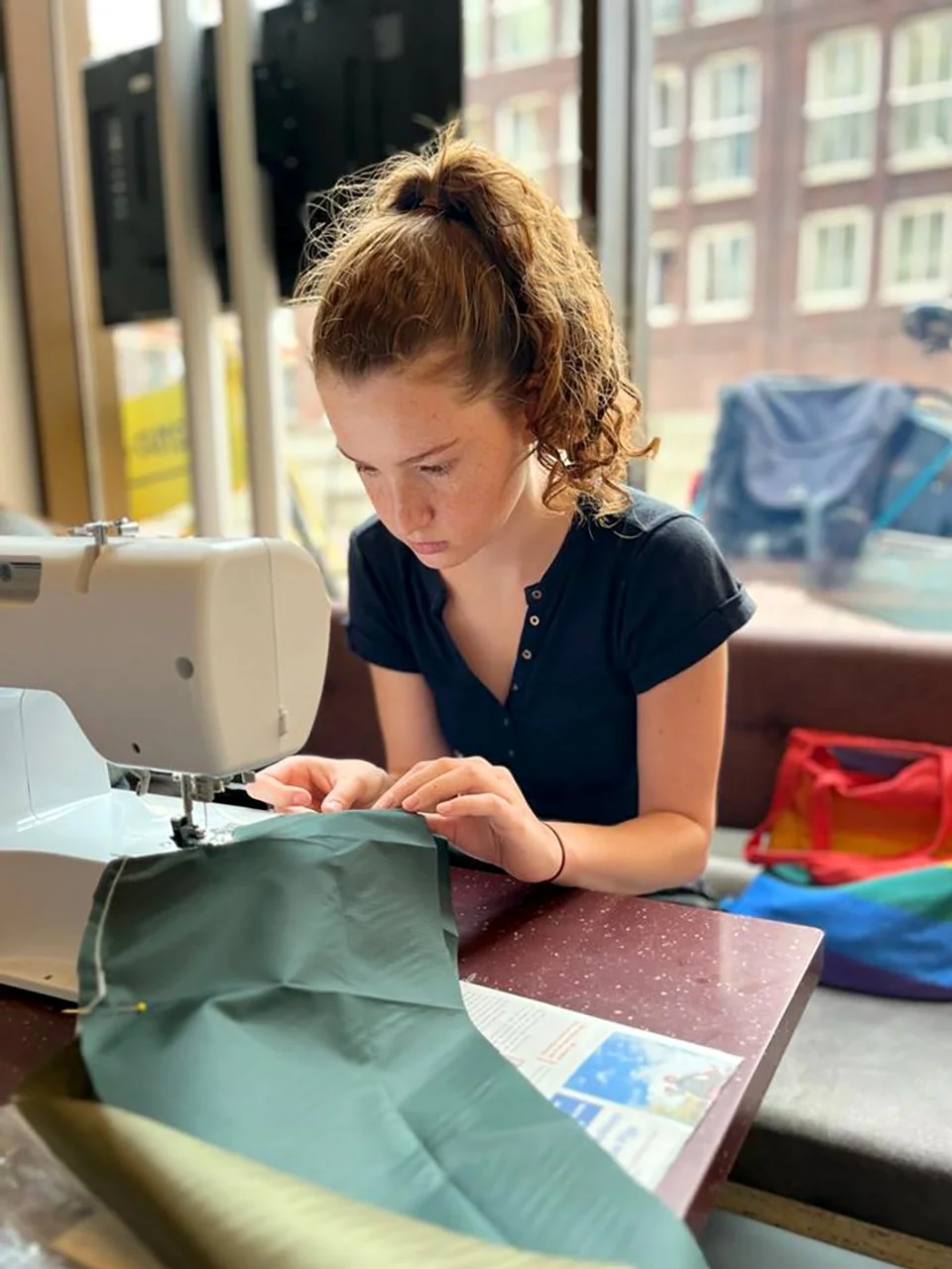 teen girl working on a sewing machine