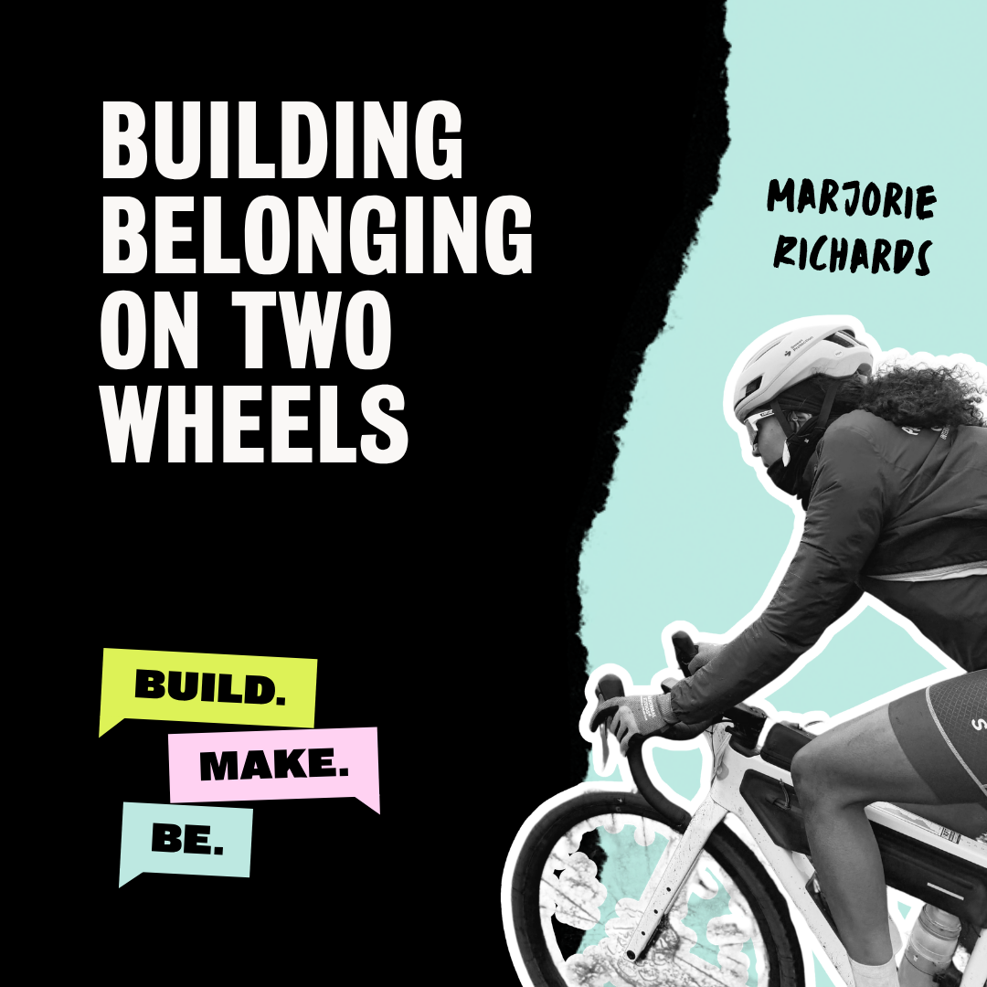 Black and white image of a woman riding a bicycle wearing a helmet and sunglasses, with a teal background. To the left, large white text reads, "Building Belonging on Two Wheels." Below, colorful speech bubbles say, "Build," "Make," and "Be." The woman's name, Marjorie Richards, is handwritten in black near her head.