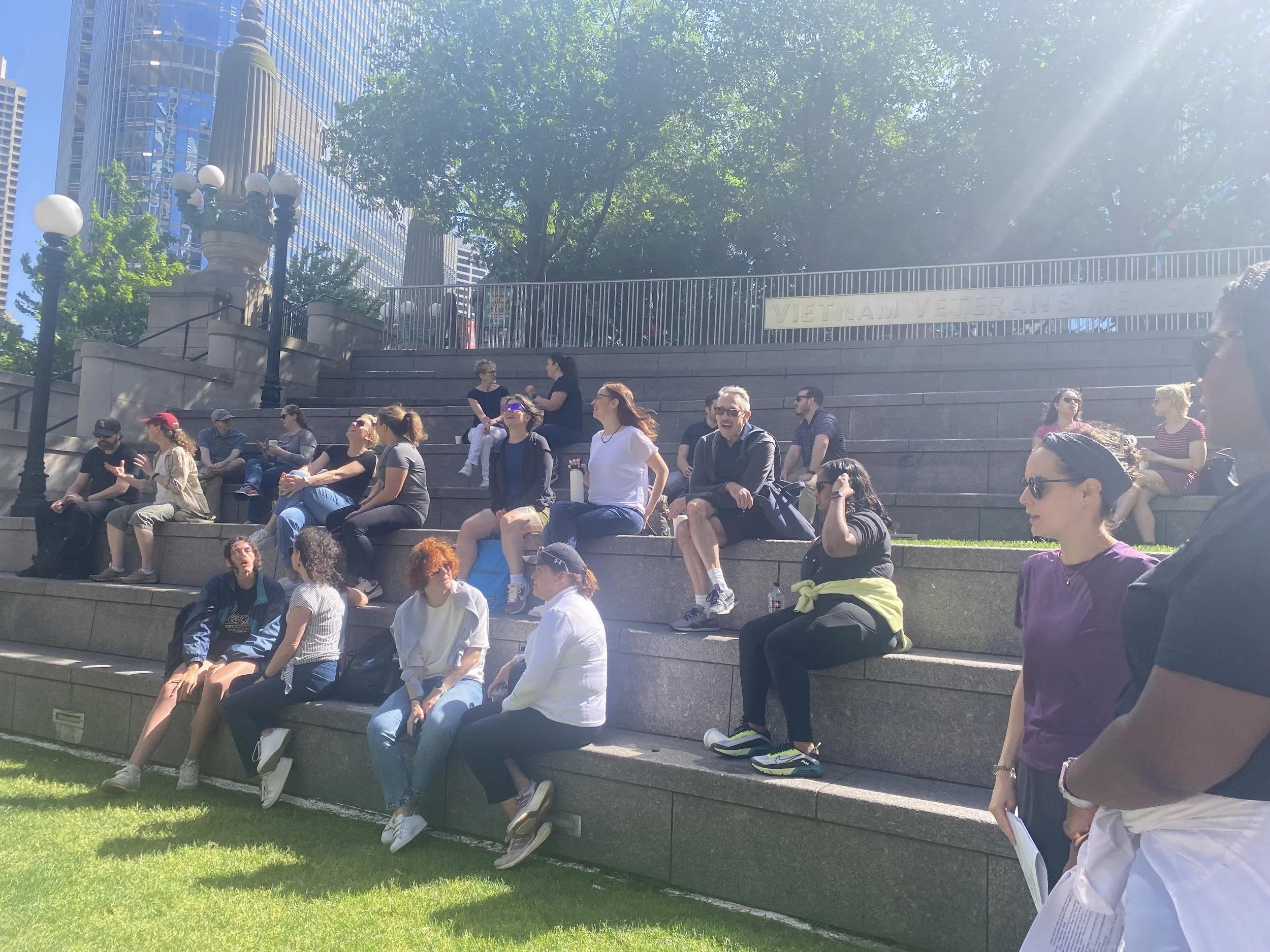 a group of people sitting on stone steps