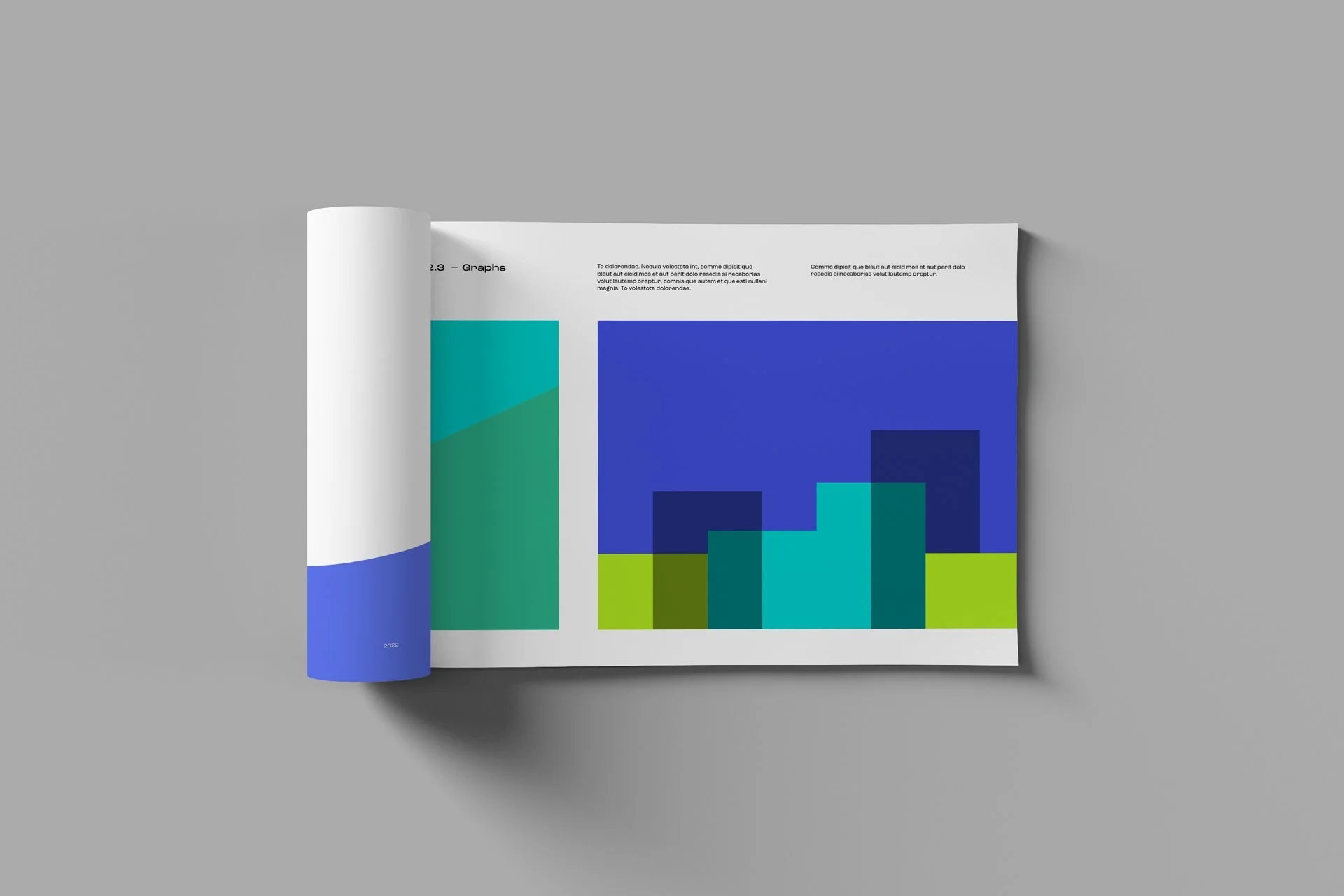 Open magazine with abstract geometric graphics and text on a gray background.