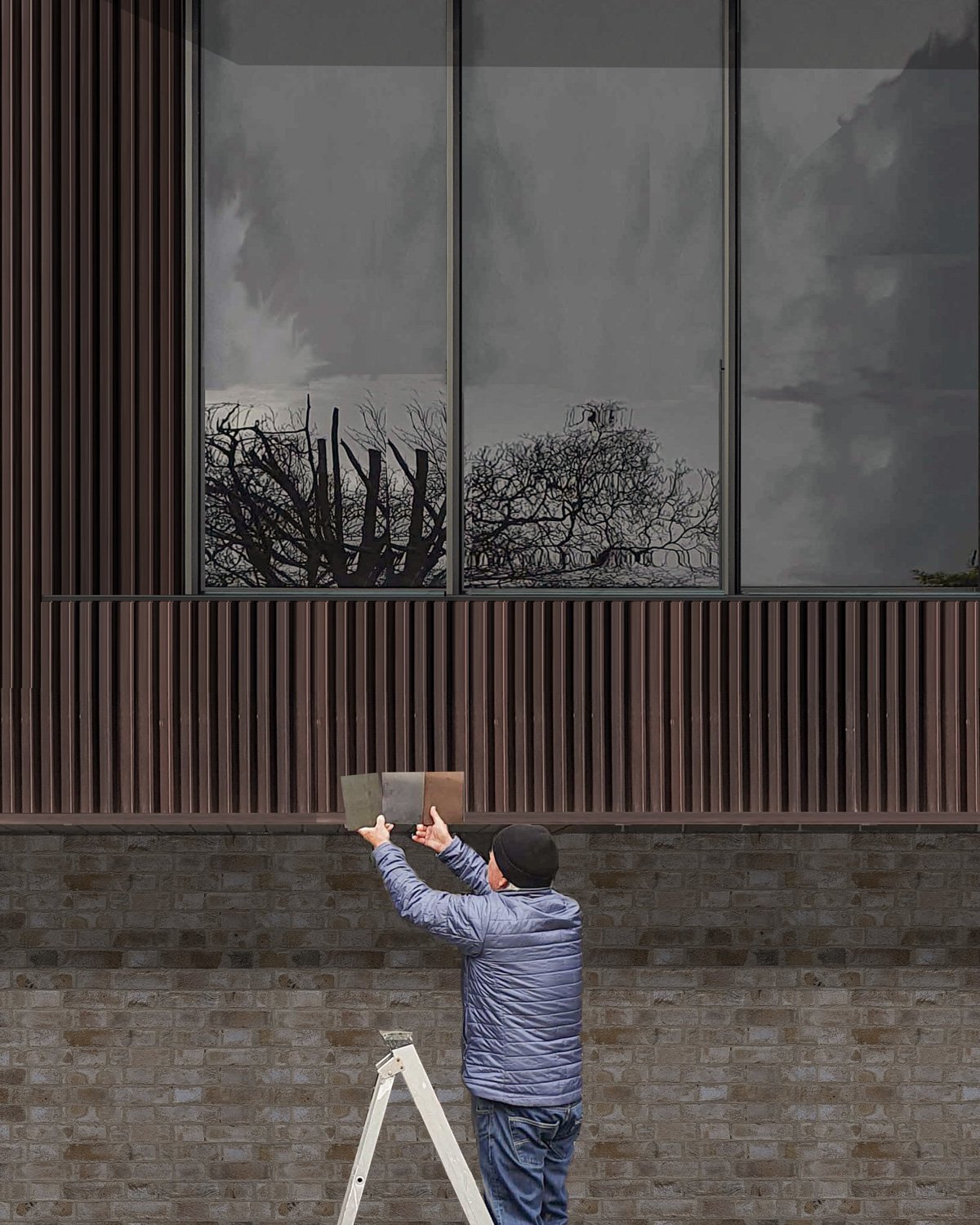 Person standing on a ladder, holding a mirror and taking a picture of a building's exterior with large windows reflecting cloudy sky and trees.