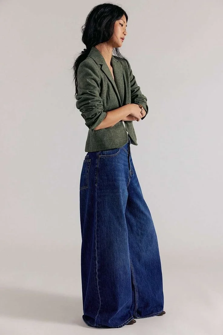 a woman wearing blazer and baggy denim