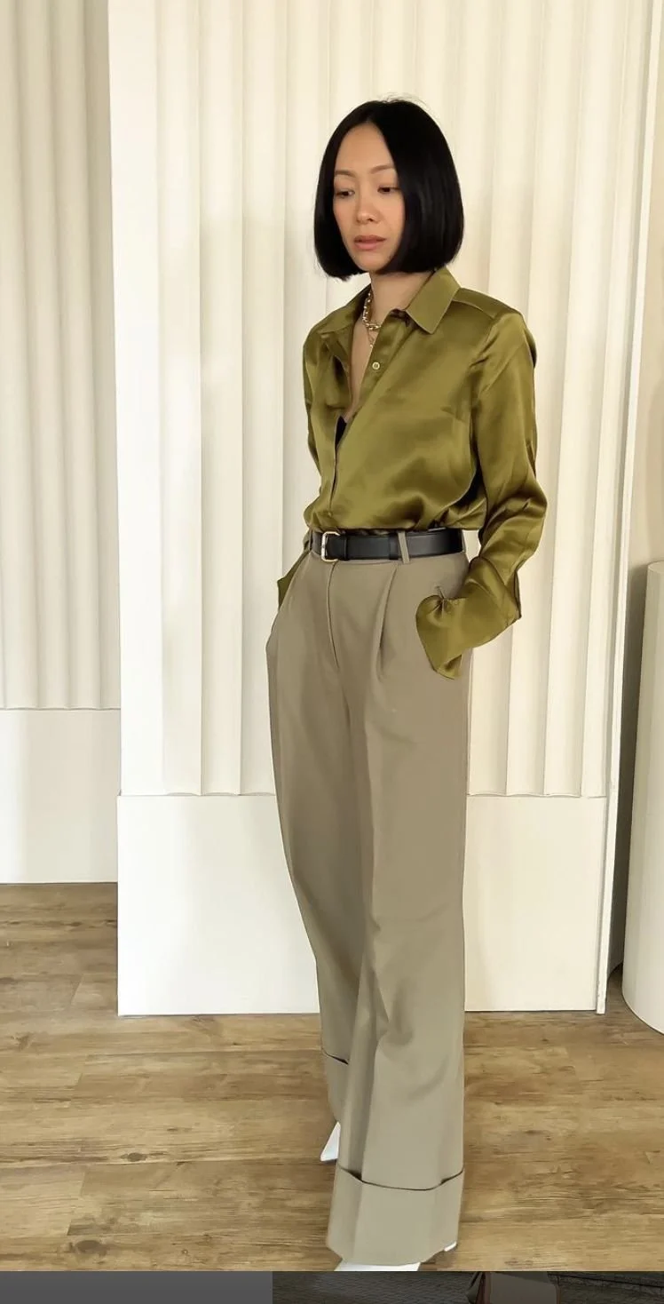 woman wearing a silk shirt and office pants