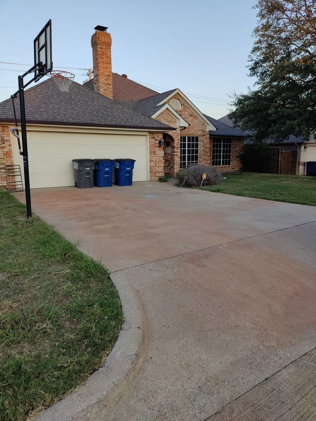 After junk removal showing clean driveway at Plano TX home