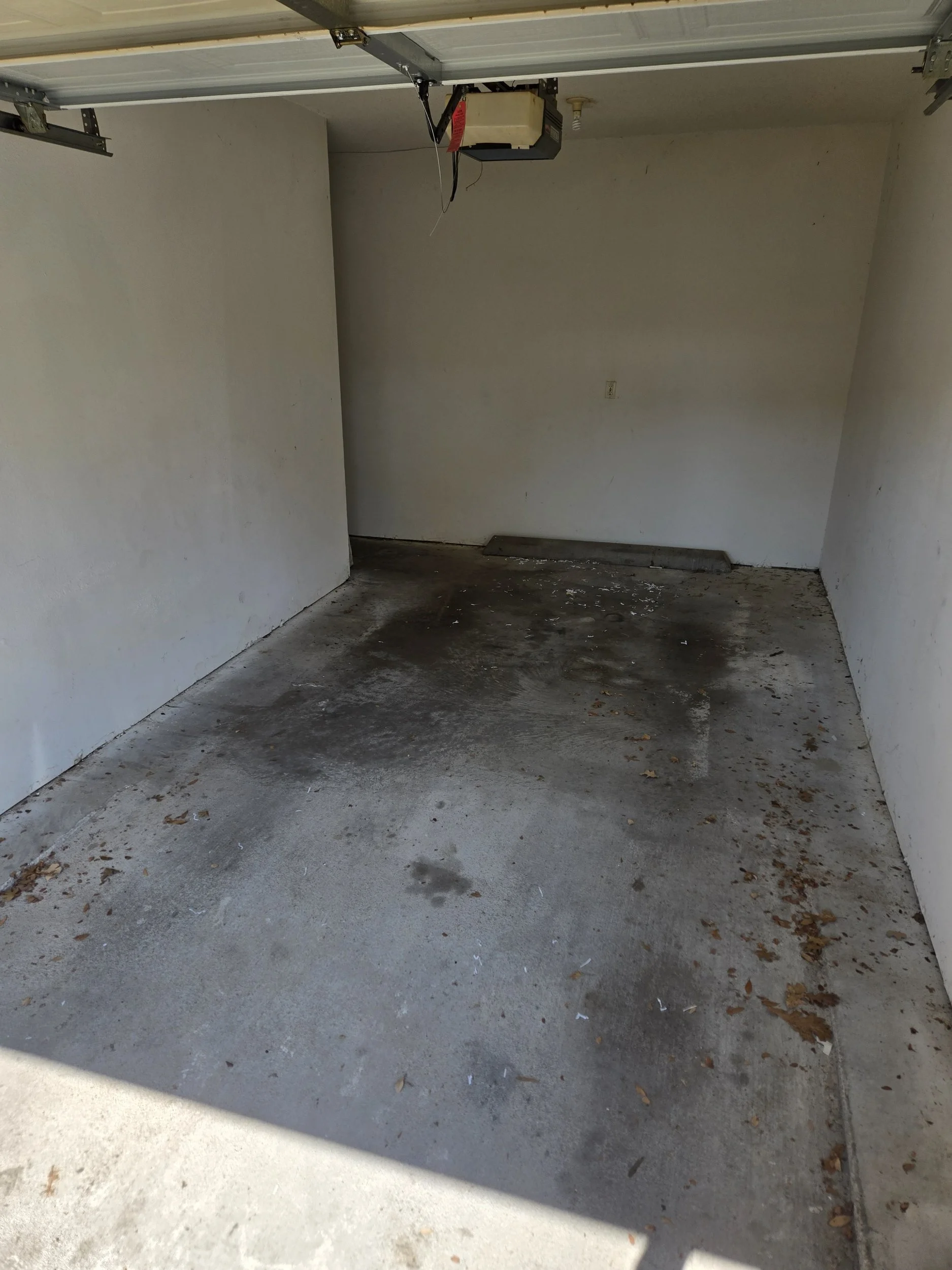 Garage after junk removal and cleanout service in Richardson, TX with unwanted items removed and the space cleared.