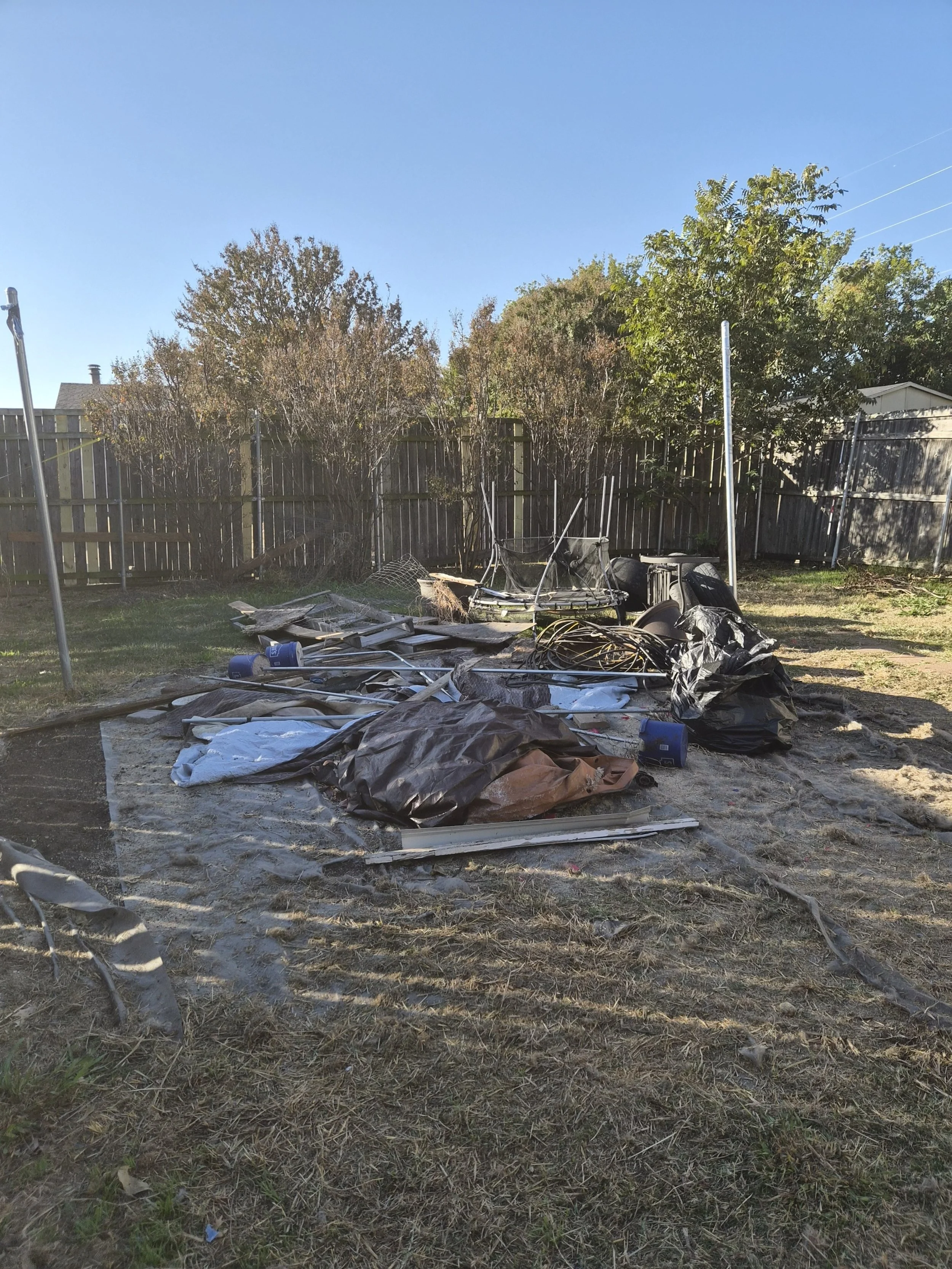 Yard debris removal before photo – junk and trash cleanup in Plano TX backyard.