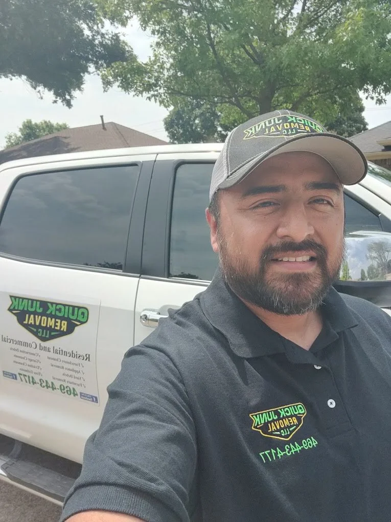 Owner of Quick Junk Removal standing in full uniform in front of our company truck, prominently displaying the Quick Junk Removal logo, showcasing our professional junk removal services