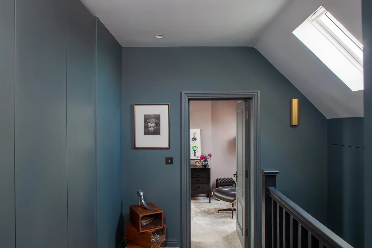 Completed loft landing with rooflight, timber flooring and dark balustrade