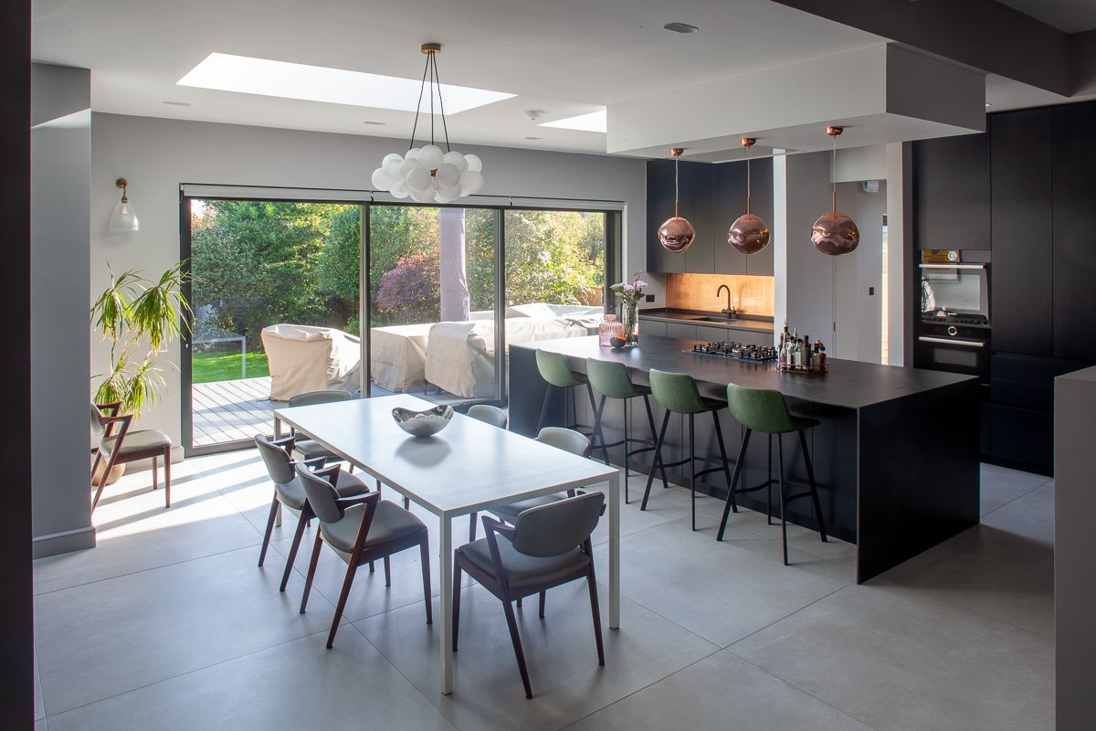 Open-plan London kitchen within a completed rear extension with full-width glazing to the garden