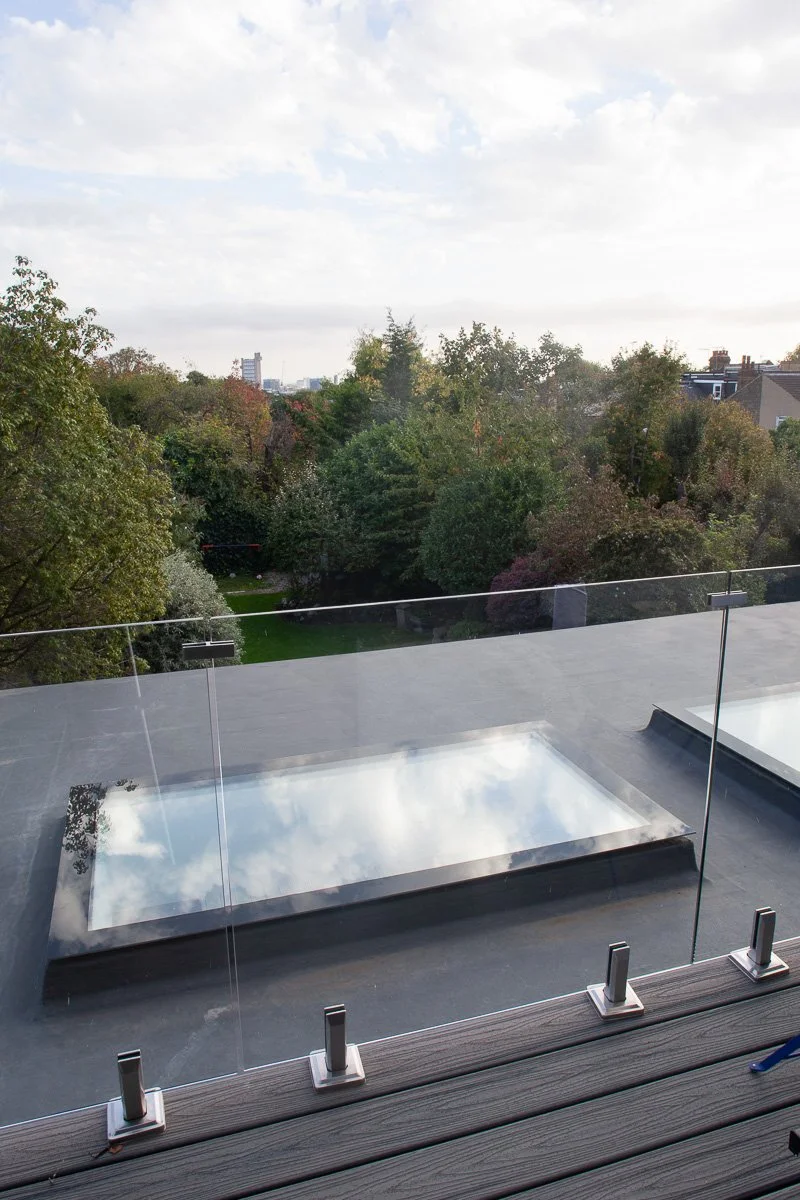 Close roof-level view of tiles, rooflights and completed loft conversion detailing