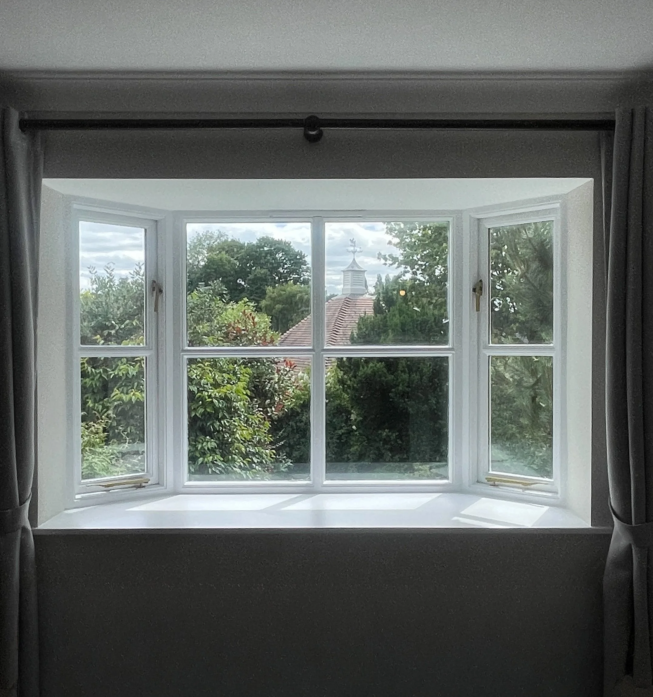 Newly finished bedroom window interior with garden view in London property