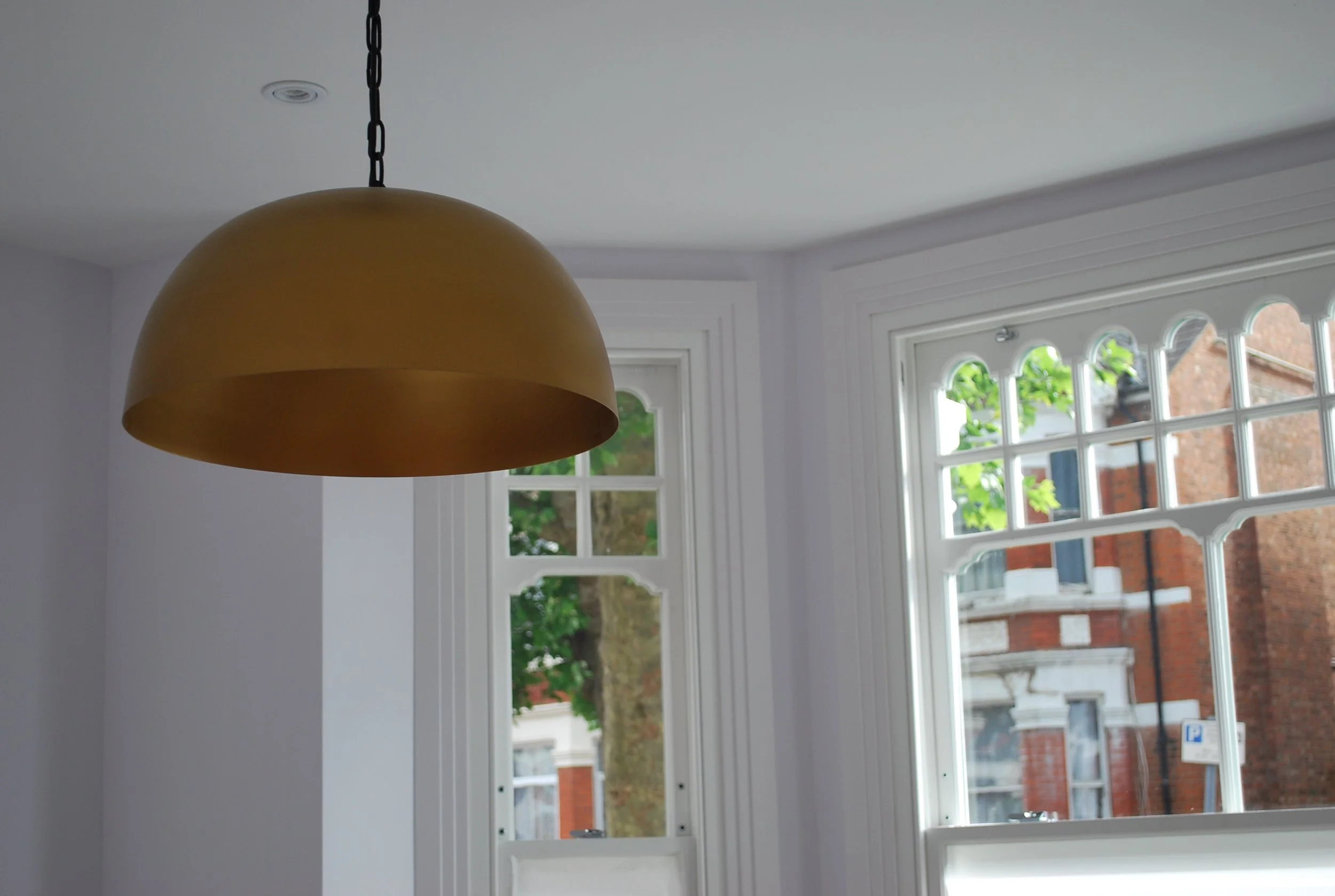 Restored period window and interior lighting detail within a London refurbishment