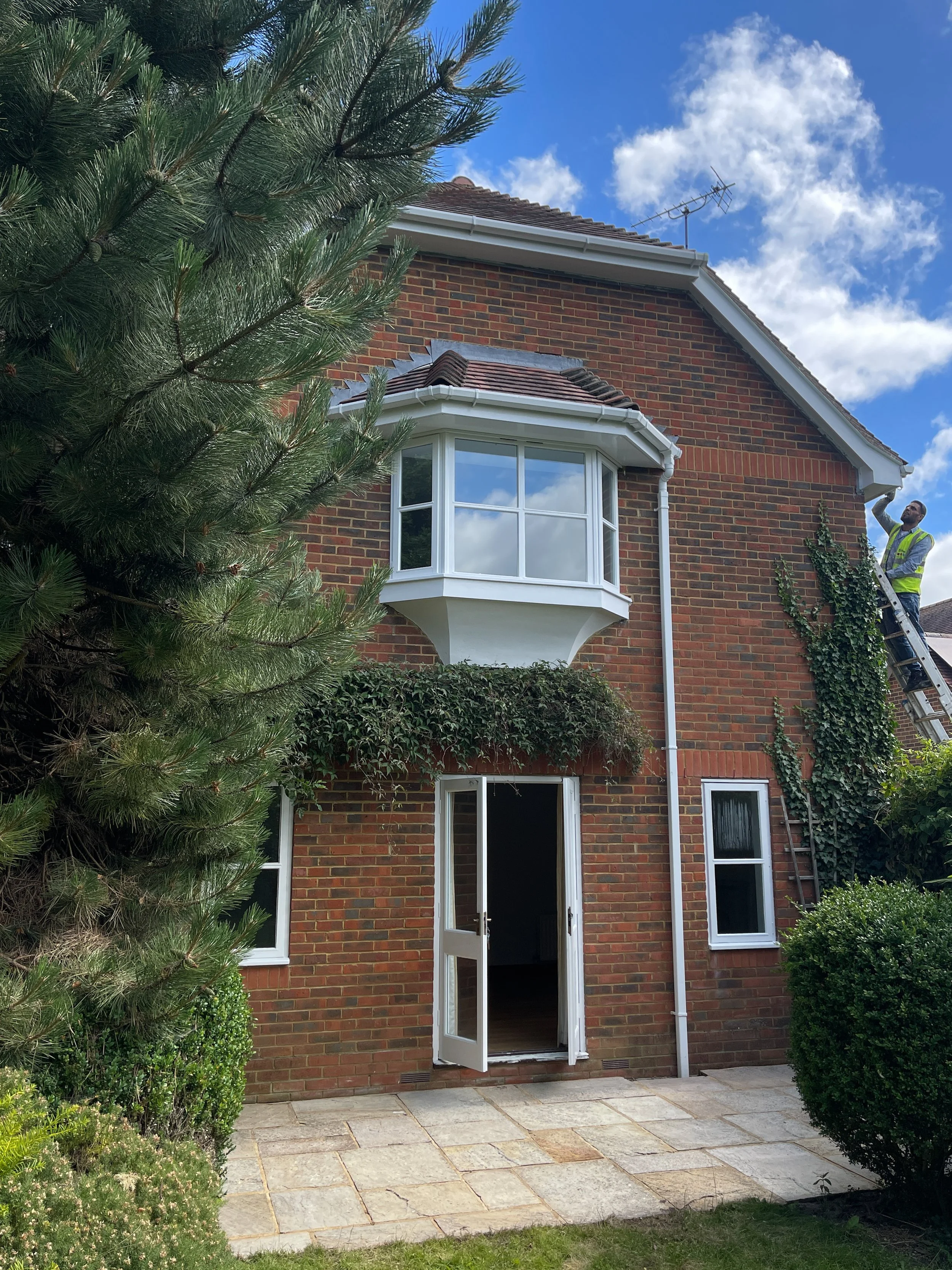 Renovated exterior with new bay window and garden patio in London home
