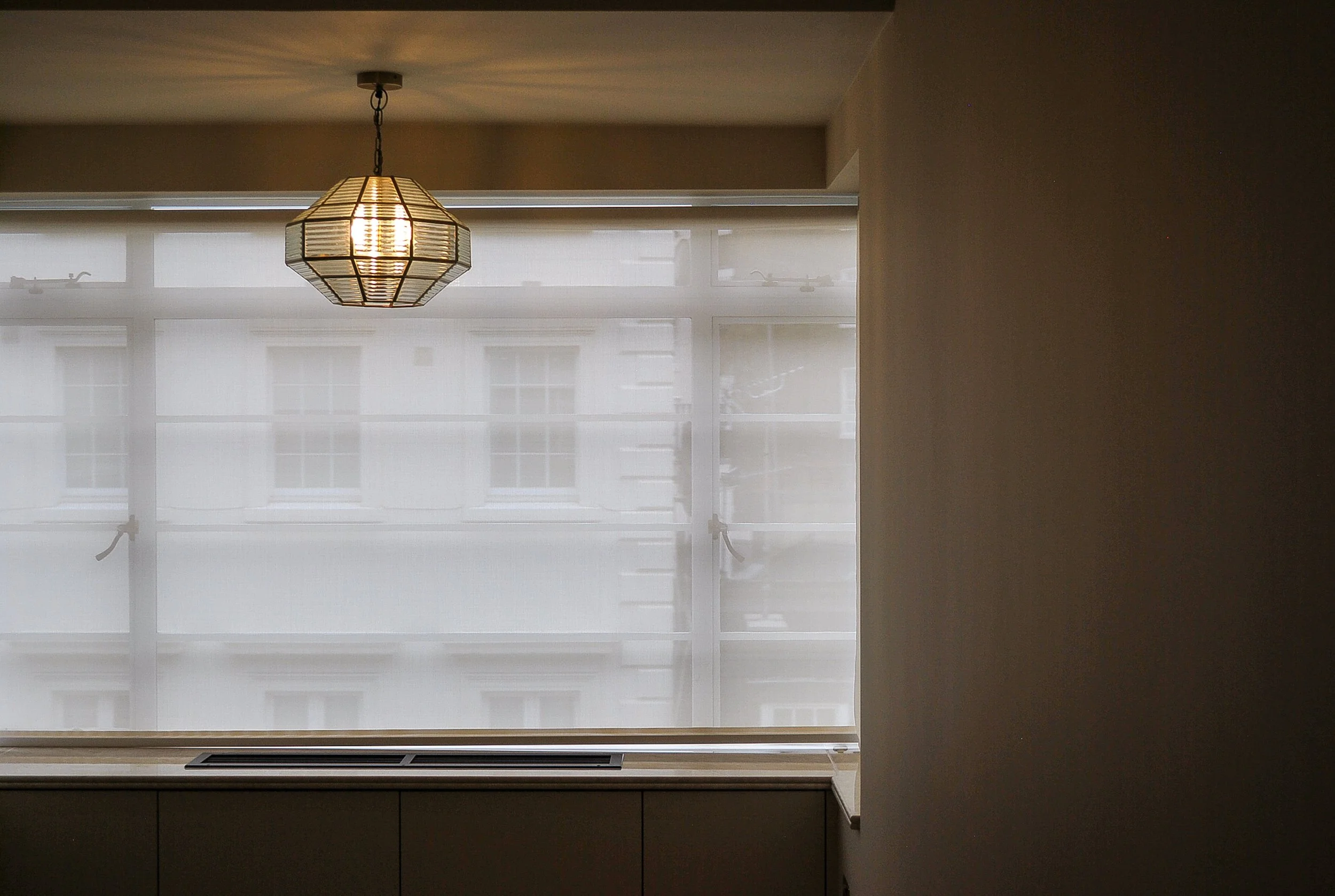 Decorative pendant lighting installed above a finished London interior