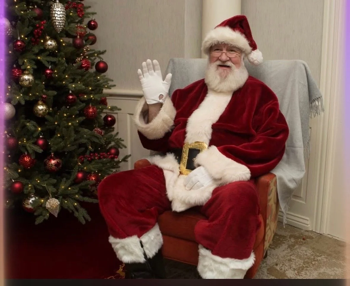 Cartoon elf wearing a red Santa hat with a yellow pom-pom, set against a dark green background.