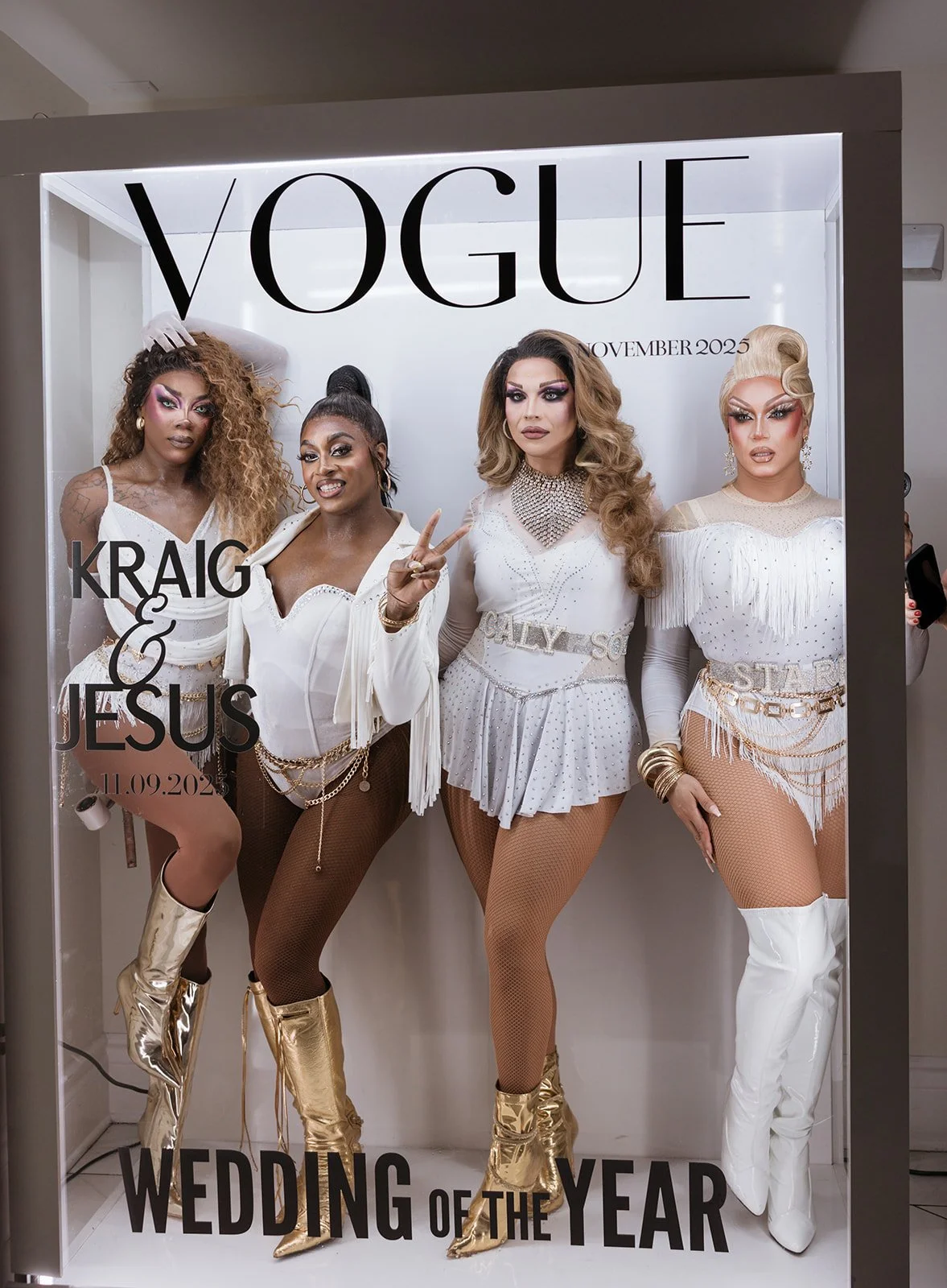 A Vogue magazine cover featuring four drag queens in white and gold outfits. The cover number is November 2025. The text on the cover reads "Kraig & Jesus" and "Wedding of the Year" with a date of 11.09.2025.