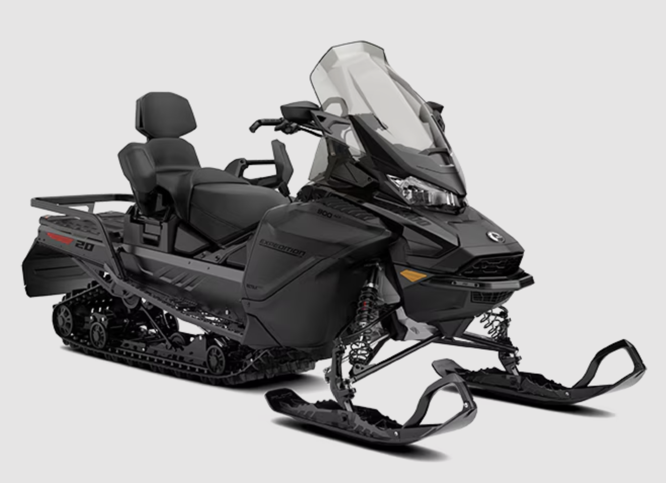 Black snowmobile with dual seats and a windshield on a white background.