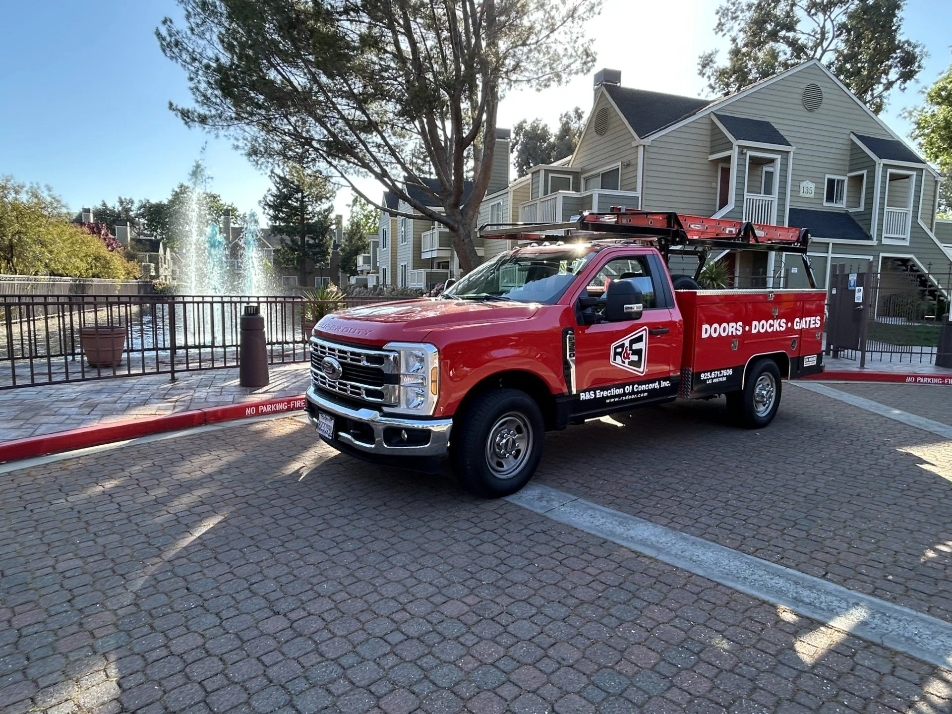 R&S red truck in front of apartment complex