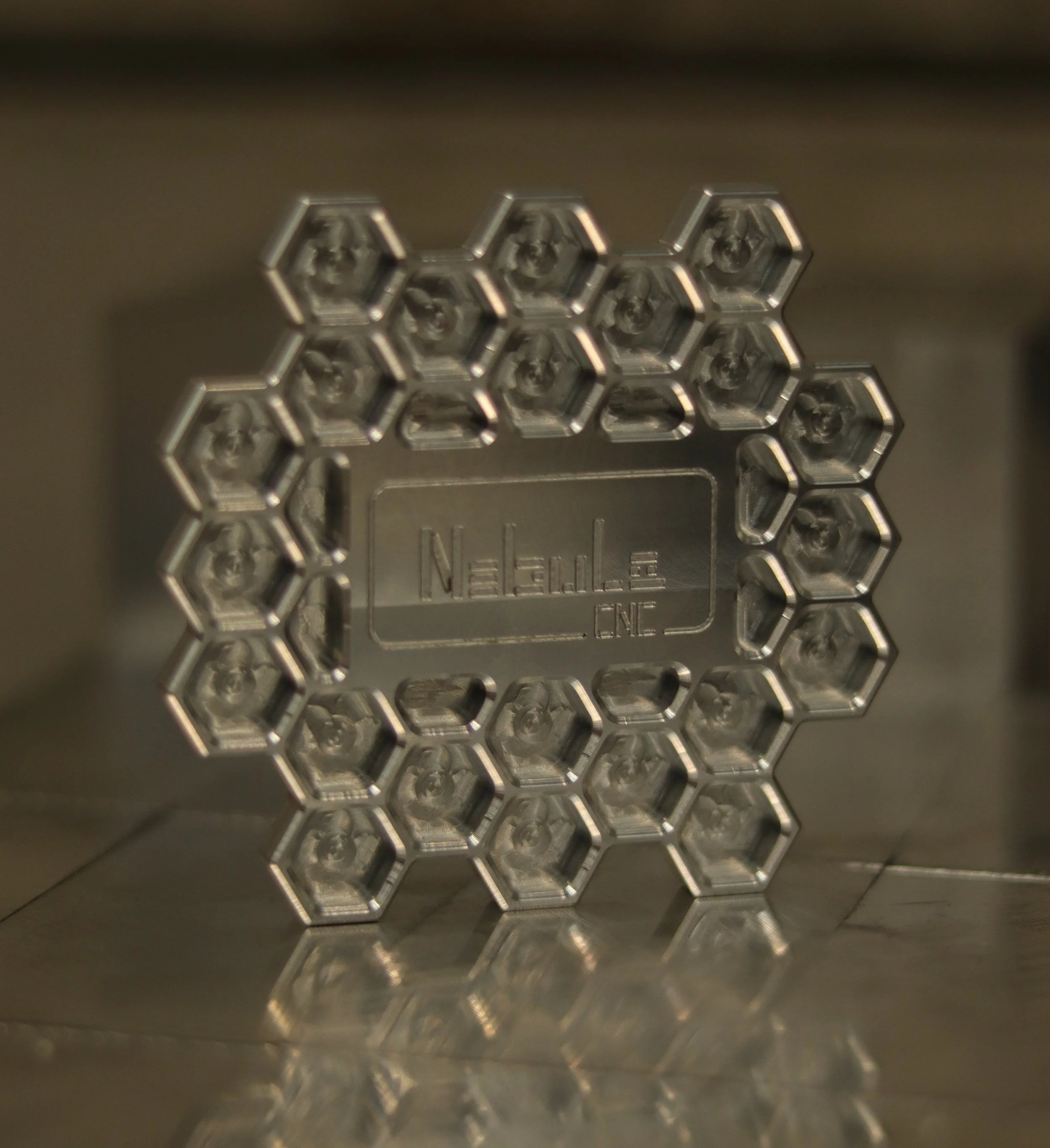 Metallic honeycomb pattern with engraved text