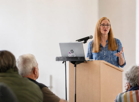 Rebecca Finegan speaking to a group of older adults