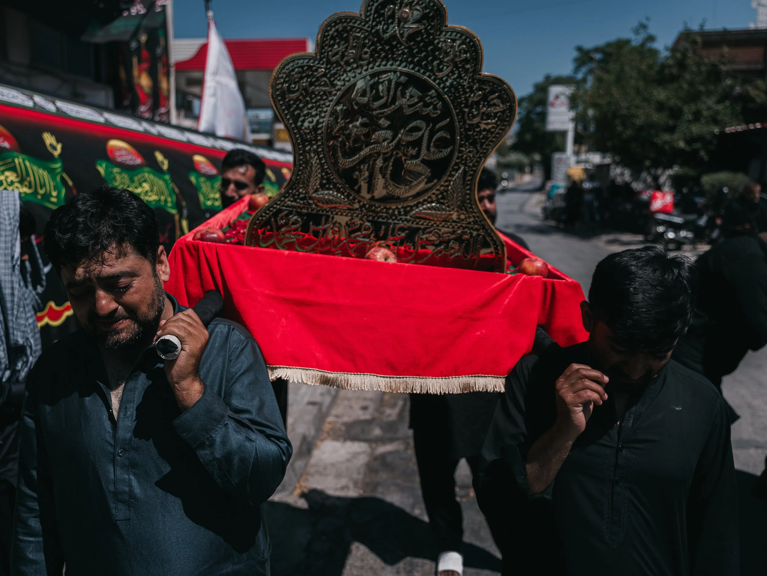 Men carry a symbolic child’s coffin and cry while walking during the Ashura rituals in Peristeri, Athens, Greece on July 6, 2025. The procession commemorates the martyrdom of Ali Asghar, the infant son of Imam Husayn, honoring his sacrifice at Karbal