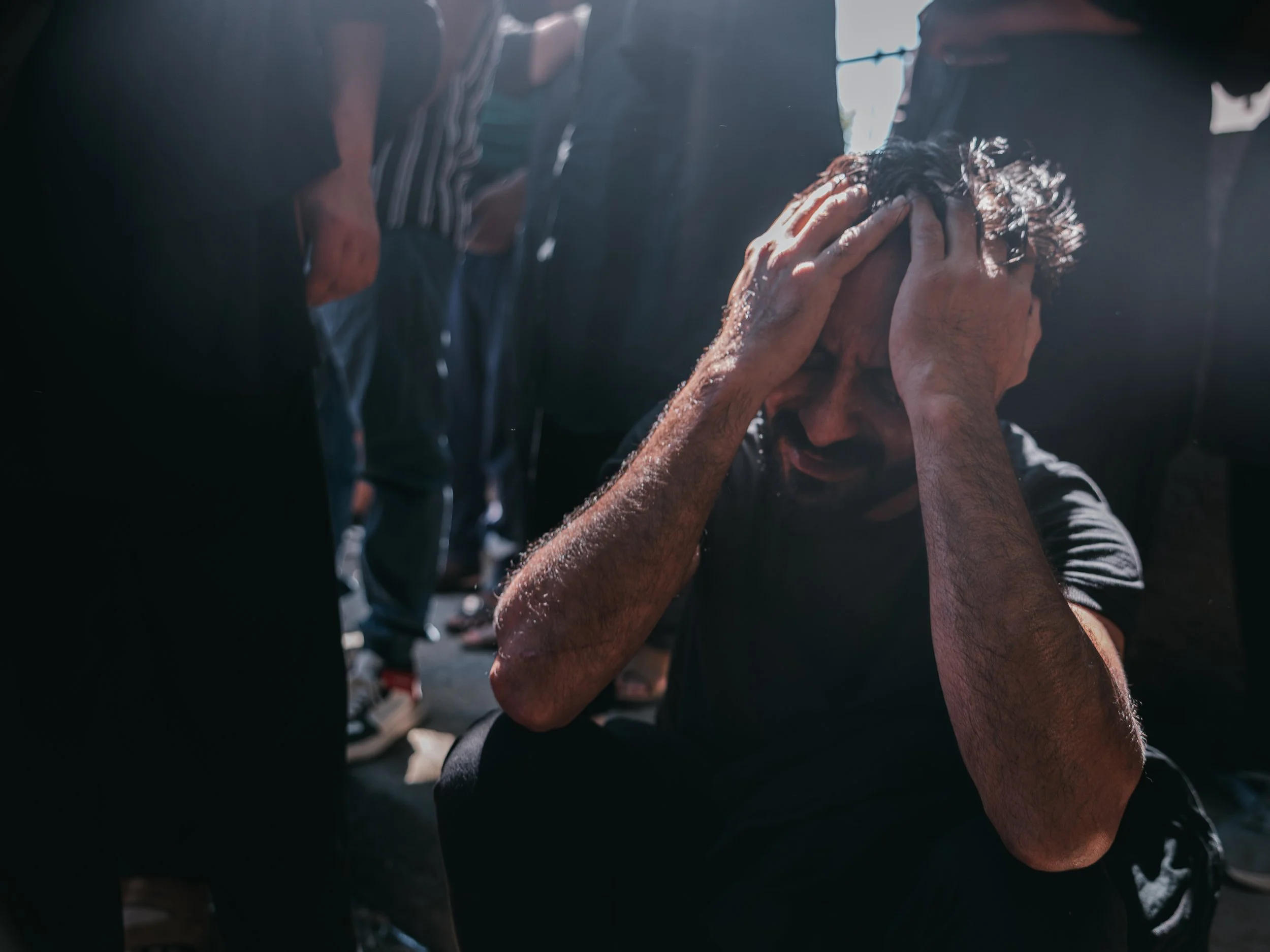 A man weeps in prayer, overcome with emotion, as he remembers the martyrdom of Imam Hussein during Ashura at a non-official mosque in Peristeri, Athens on July 6, 2025.